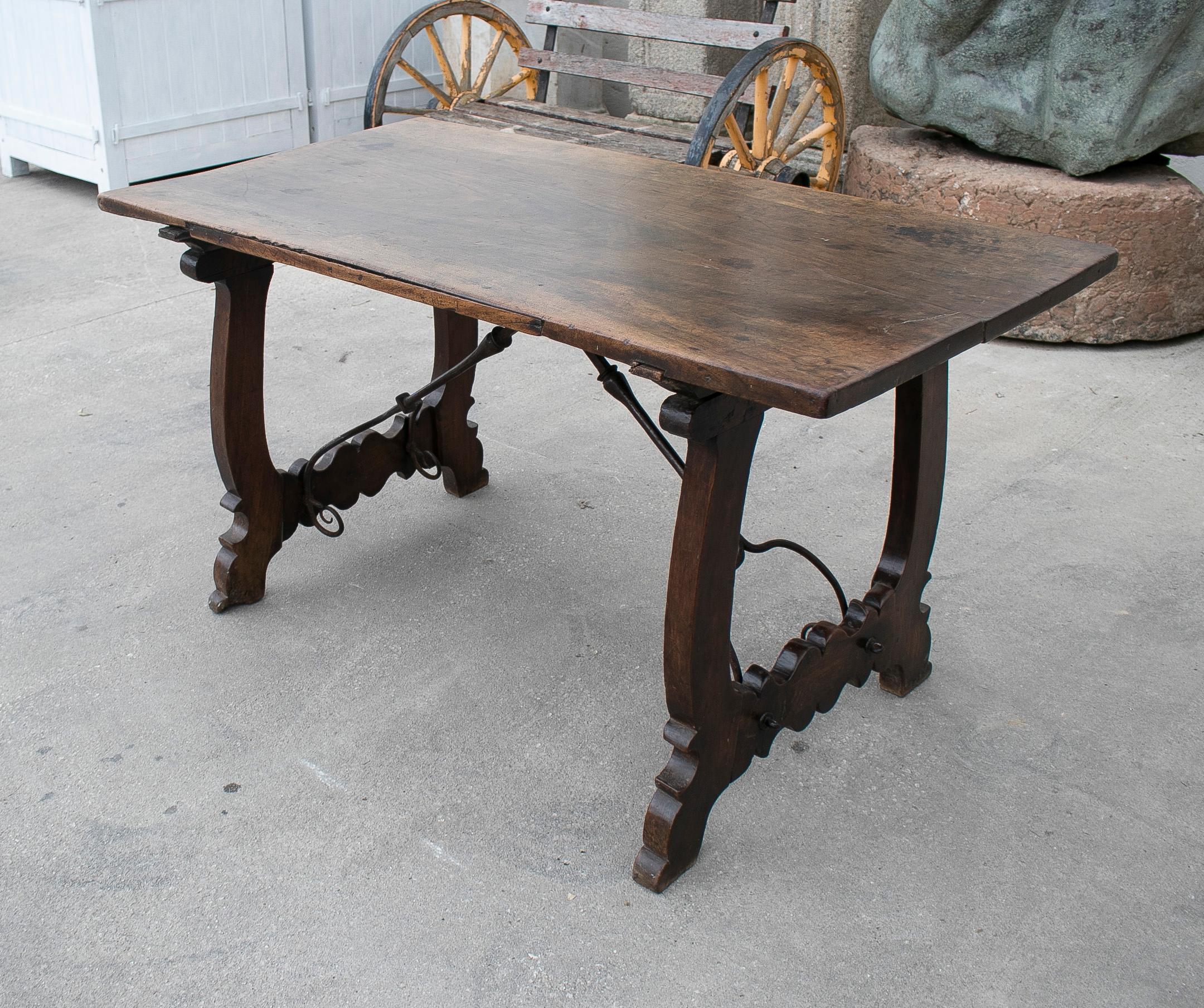 Antique 17th century Spanish walnut table with lira legs and original crossbeams and ironware.