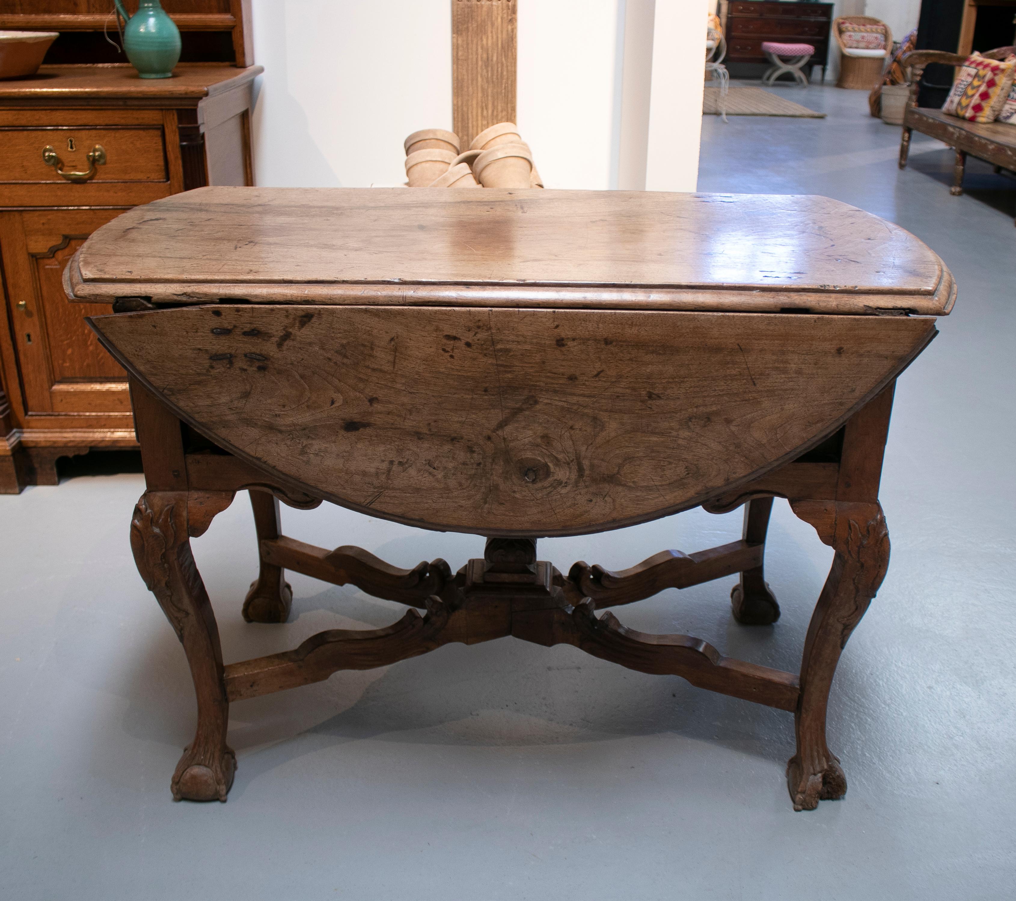Antique 17th century Spanish walnut winged table with claw feet.