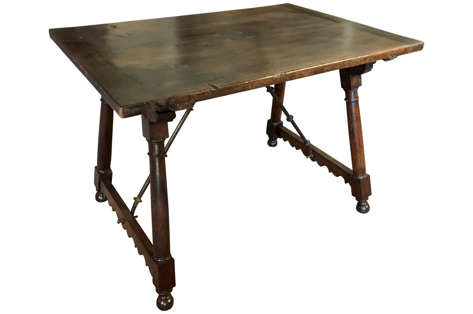 A very stunning 17th century writing table from the Catalan region of Spain. Masterly constructed with a solid board top of magnificent walnut. Sensational patina - very rich and luminous. The iron stretchers are expertly hand-forged from iron. A