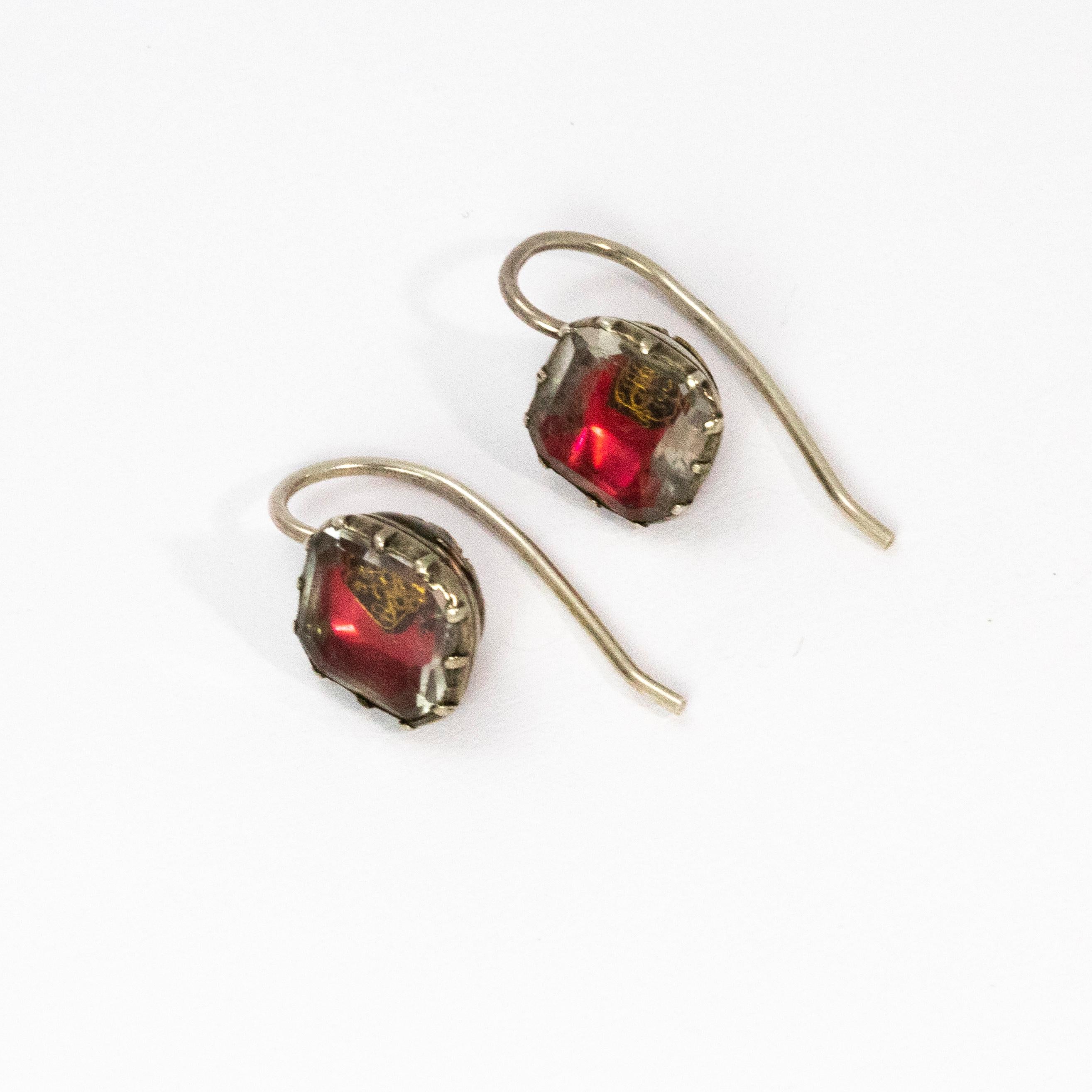 An incredible pair of Stuart crystal earrings from an iconic period of the English monarchy. Mounted in silver with classic gold wirework designs and red foil beneath the beautiful crystal. With Shepherds hook backs.

Crafted between 1650 and 1730,