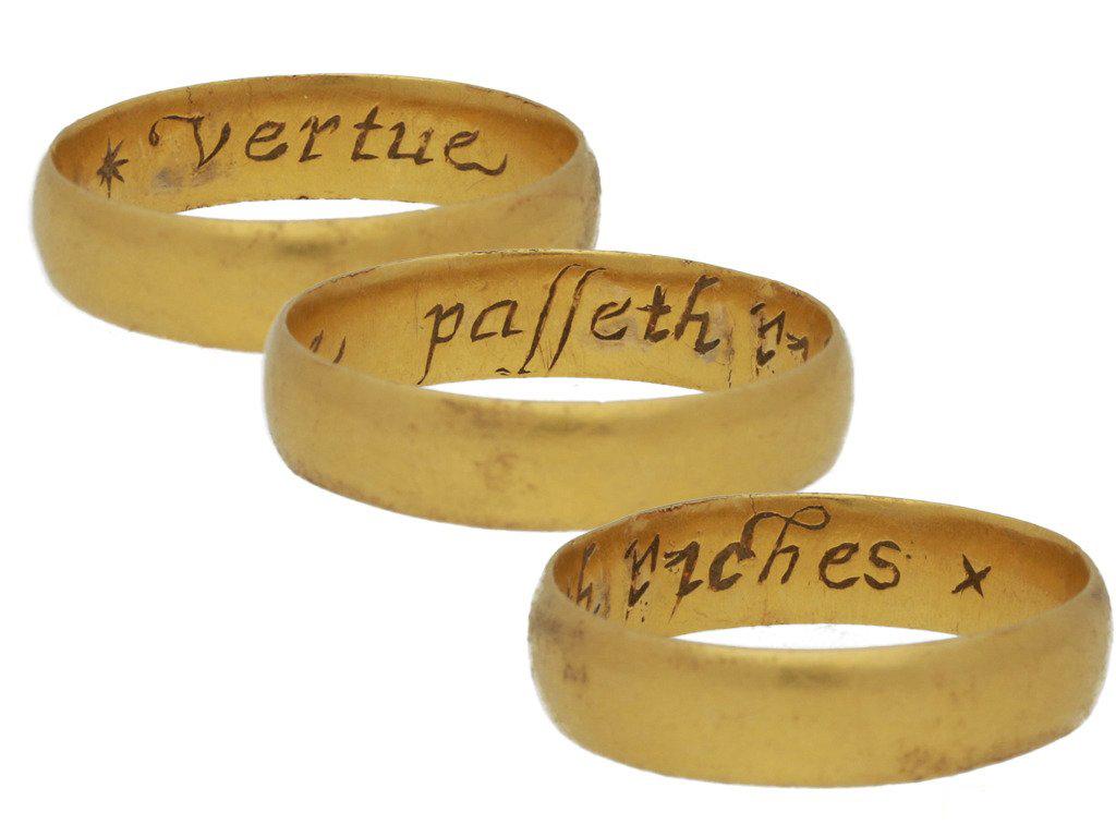 Stuart gold posy ring 'Vertue passeth riches'. A smoothly conforming shallow D-shape band, engraved to the interior in florid italic script '* Vertue passeth riches x', approximately 4.6mm in width, approximately 3.6g in weight. Tested yellow gold,