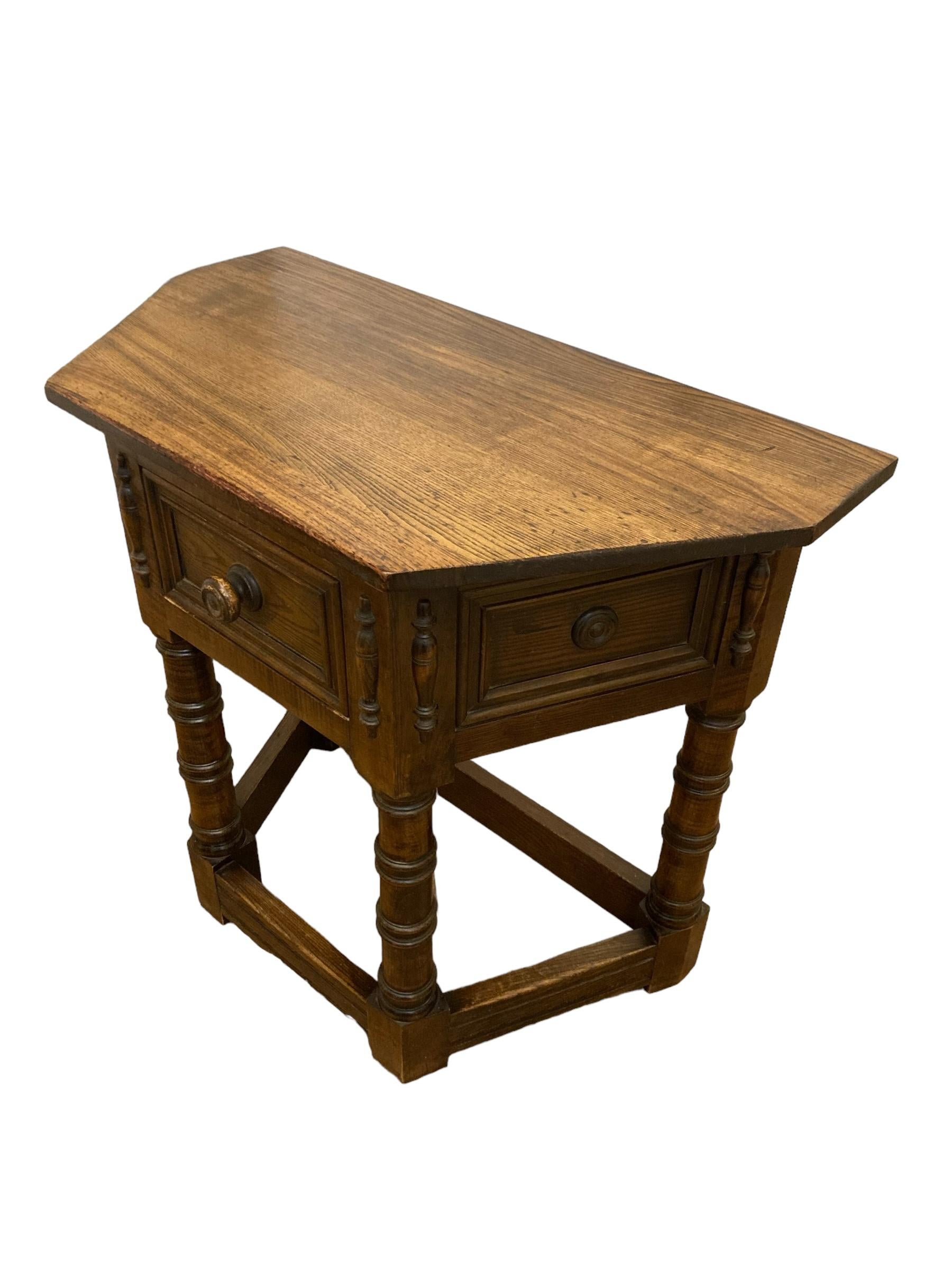 17th Century Style Gothic Look Oak Credence Side Hall Table. This timeless piece exudes elegance and charm. Crafted from high-quality oak, this table showcases a rich, warm finish that highlights the natural beauty of the wood. With its classic