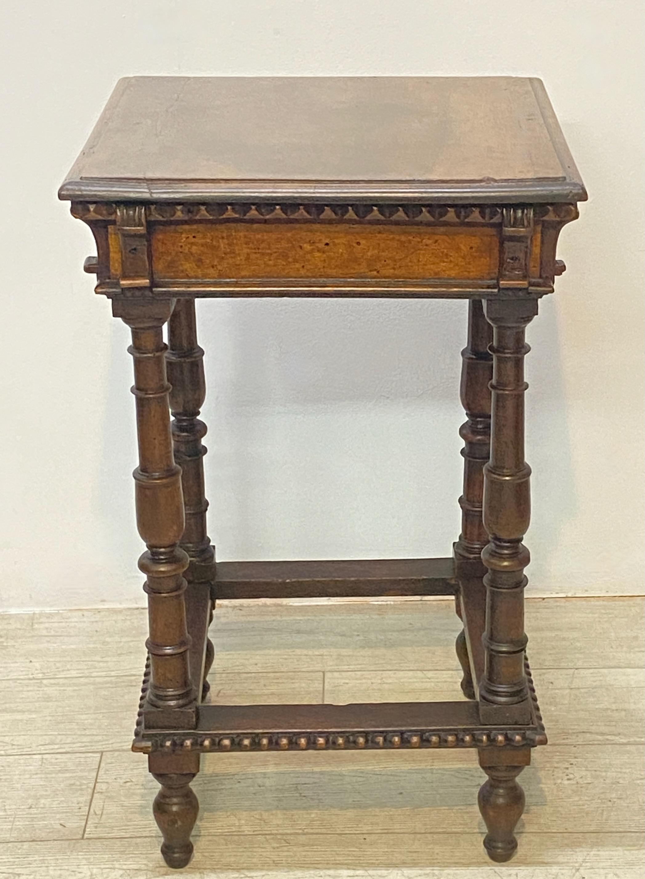 A solid carved walnut side table made up of some (17th century) period parts, likely assembled in the mid to late 19th century.
 