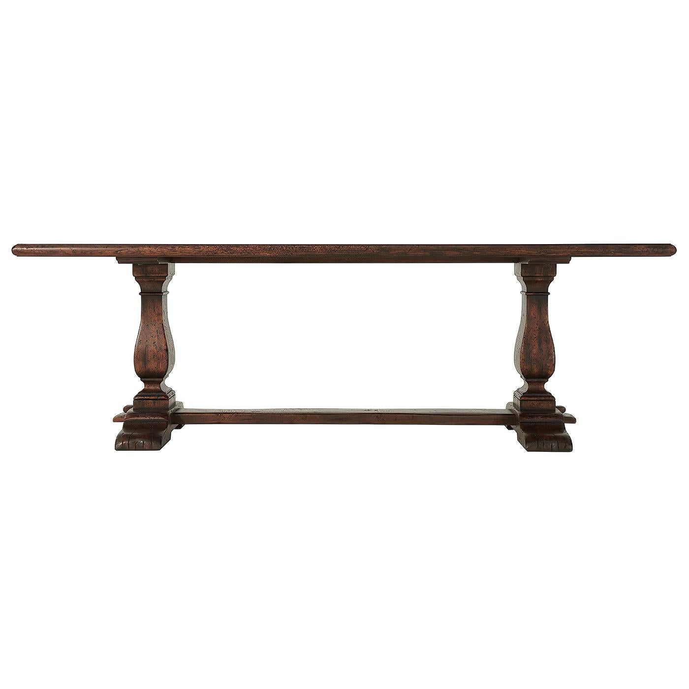 A reclaimed oak veneered refectory table, the planked rectangular moulded edge top above vase column supports and bases joined by a long stretcher. Inspired by a 17th century English original.

Dimensions: 92