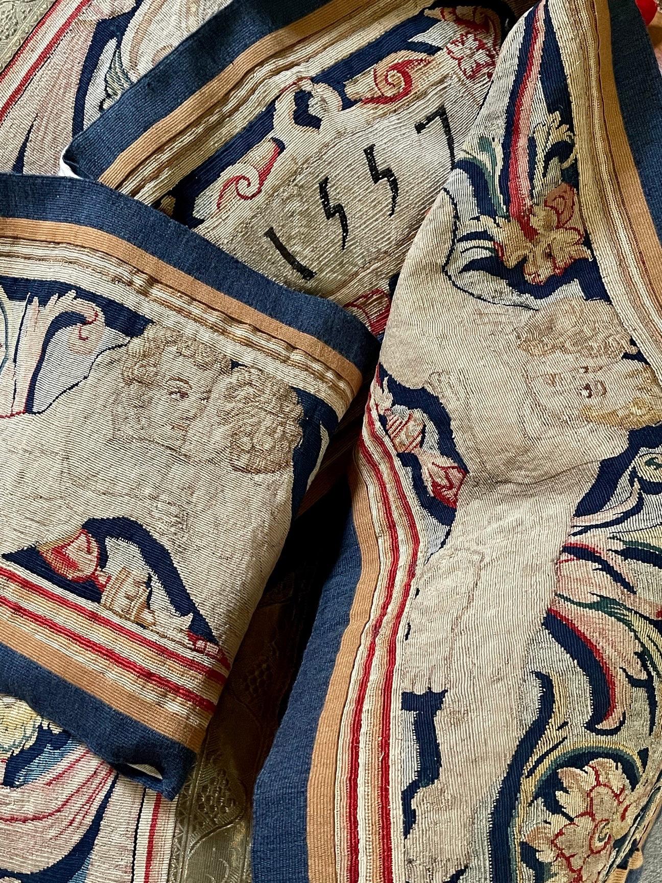 An impressive tapestry valance / pelmet

Flemish and dating from early 17th century (circa 1620)

Skillfully hand woven in wools and silks

Depicting a central cartouch bearing the date 1557 flanked on either side by

a pair of embracing putti

