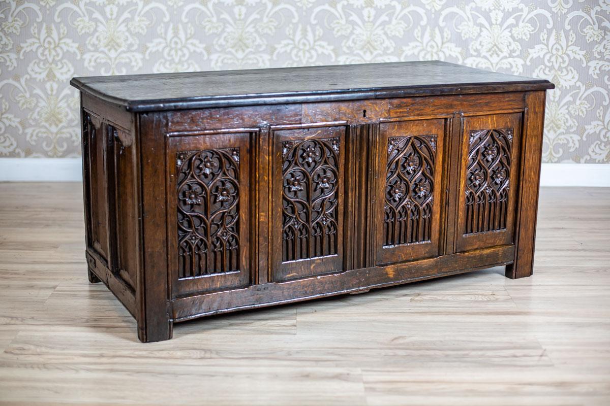 We present you a big oak chest from the 17th century, partially converted in the later period.
The front panel is divided into sections with a relief decoration in the Tudor style.

There are tracers after originally mounted old iron hinges on