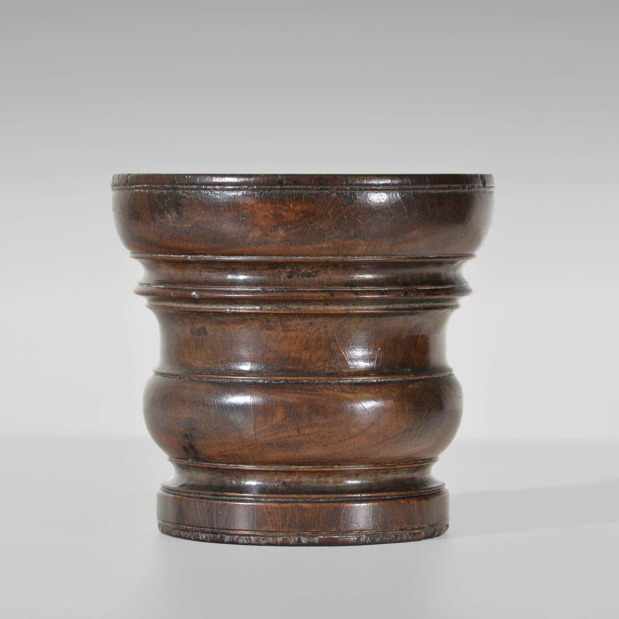 A Charles II turned lignum-vitae mortar of flared form with ring turnings over low baluster waist to a plain foot. To the underside are fine ring turnings as seen on bronze mortars. Particularly good condition, colour and patination.
English, circa