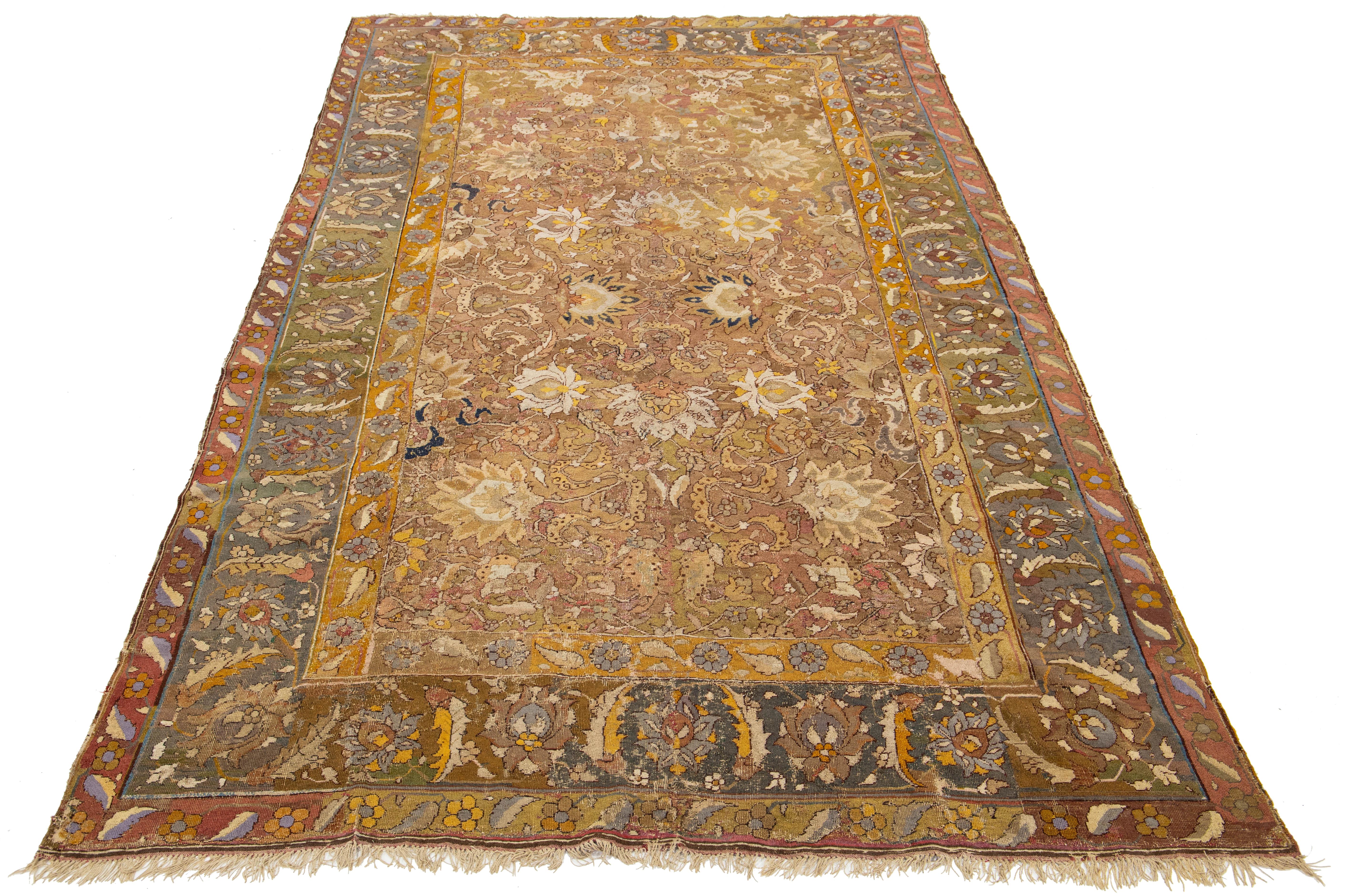 This exquisite 17th-century Persian Isfahan rug showcases a unique handmade craftsmanship, exemplifying the rich artistry of the era. Crafted from soft brown wool, the rug features an intricate floral design that reflects the elegance and