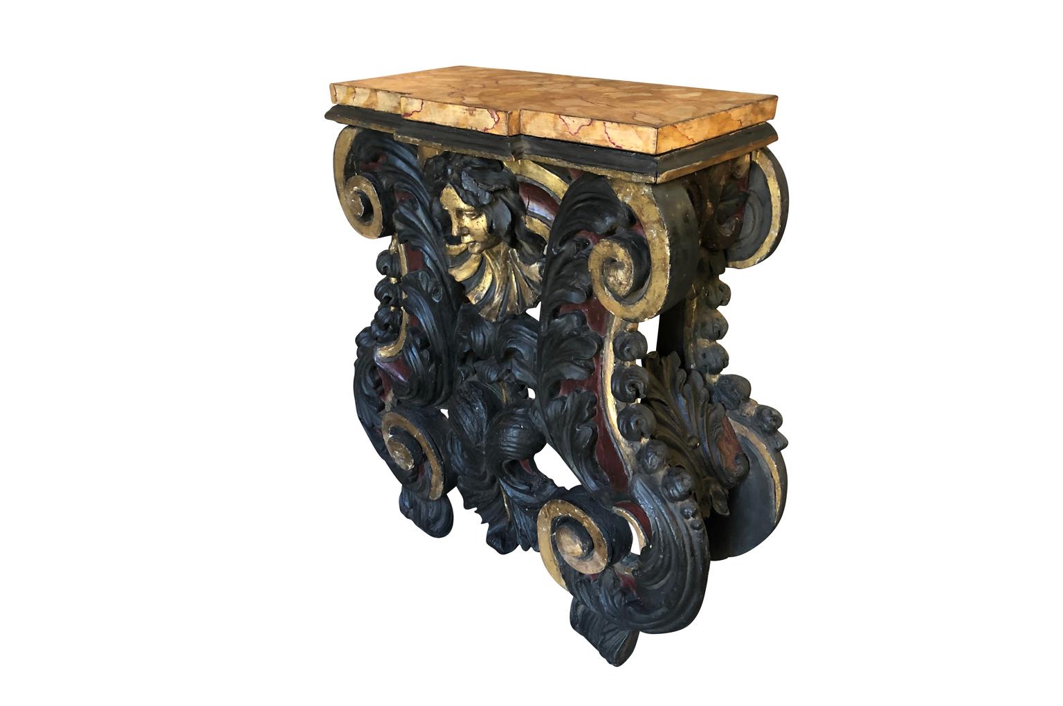 A spectacular and outstanding 17th century Venetian Console. Superbly crafted from hand carved wood with a polychromed and gilt finish. The removable top has a stunning Faux Marble finish. The original purpose of such a console was to have a statue