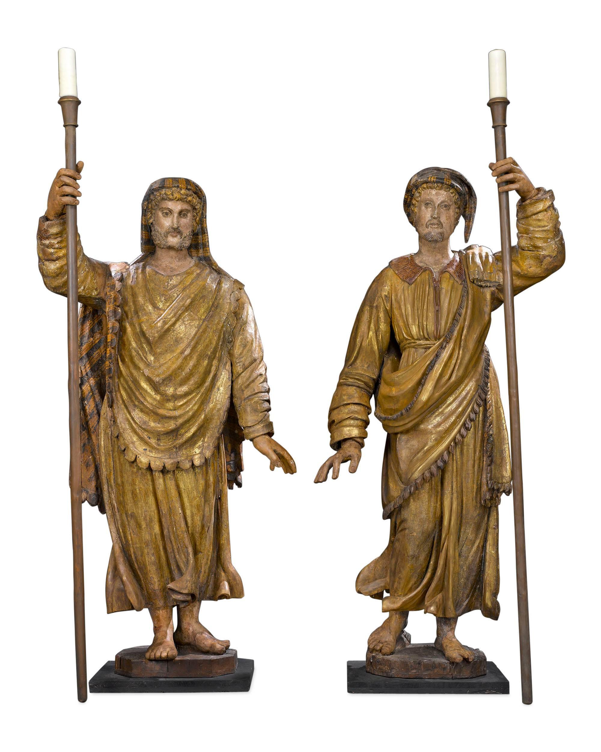 Awe-inspiring in size and artistry, these incredible Venetian figural torchères pay homage to two of Italy’s most celebrated merchant explorers–Marco Polo and Amerigo Vespucci.

Standing over nine feet high, these impressive carved wood sculptures