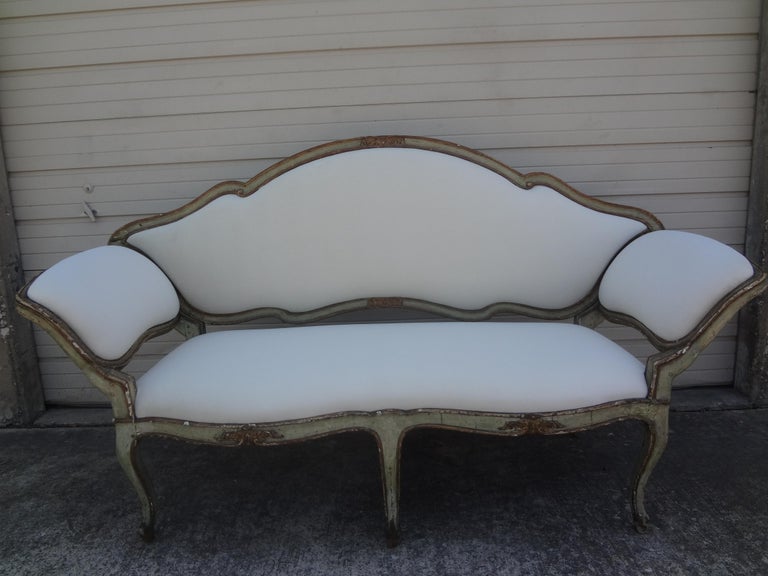 17th Century Venetian painted and parcel gilt gondola sofa. This gorgeous antique venetian sofa or canape has been newly upholstered in a plush white short pile mohair type fabric. Stunning!