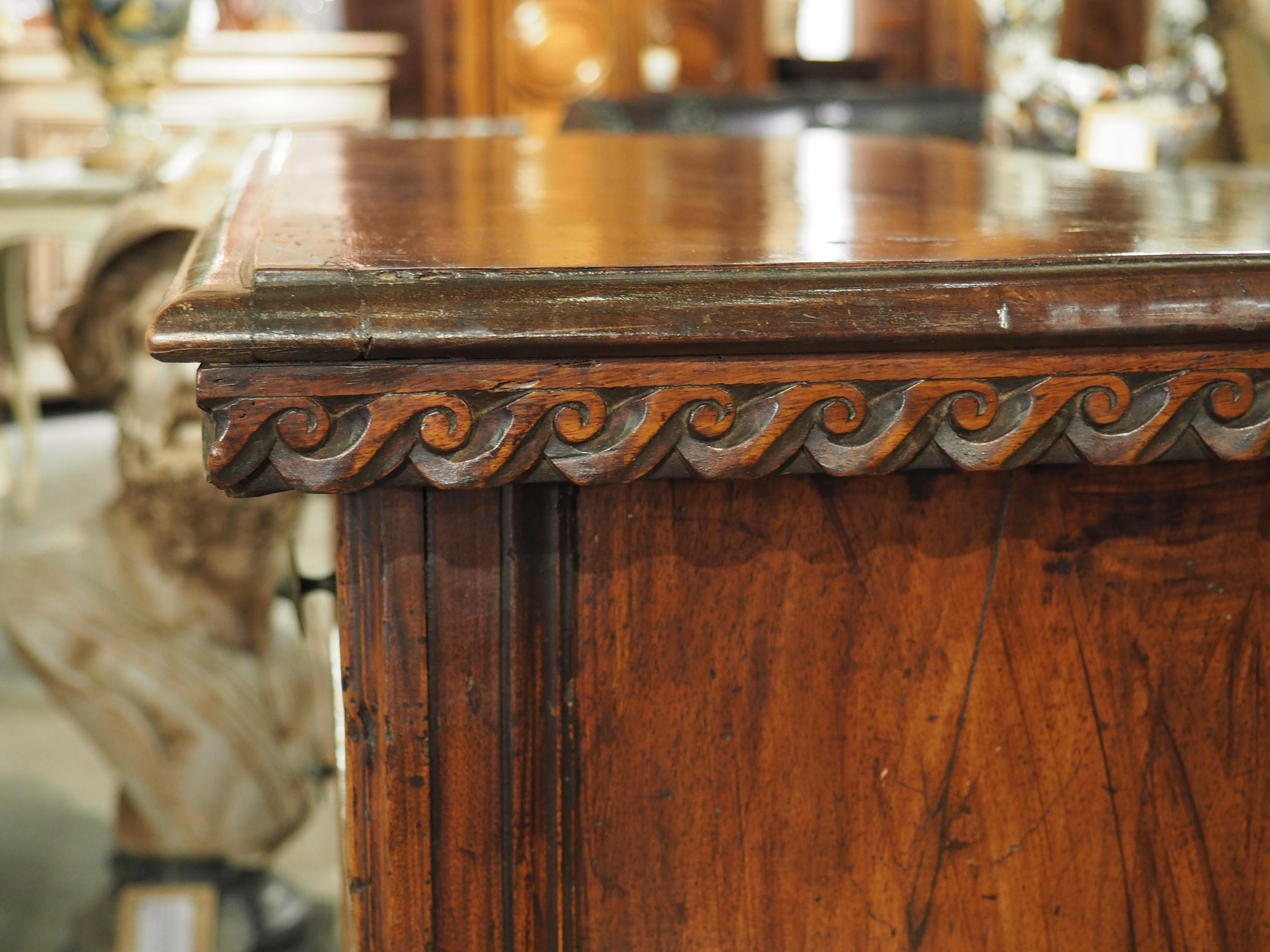 Hand-carved during the 1600’s in Tuscany, Italy, this unique commode features both regular grain and burl walnut wood. Burl is abnormal growth that arises from stress to a tree and it typically manifests as a ball on the trunk or branches. Although