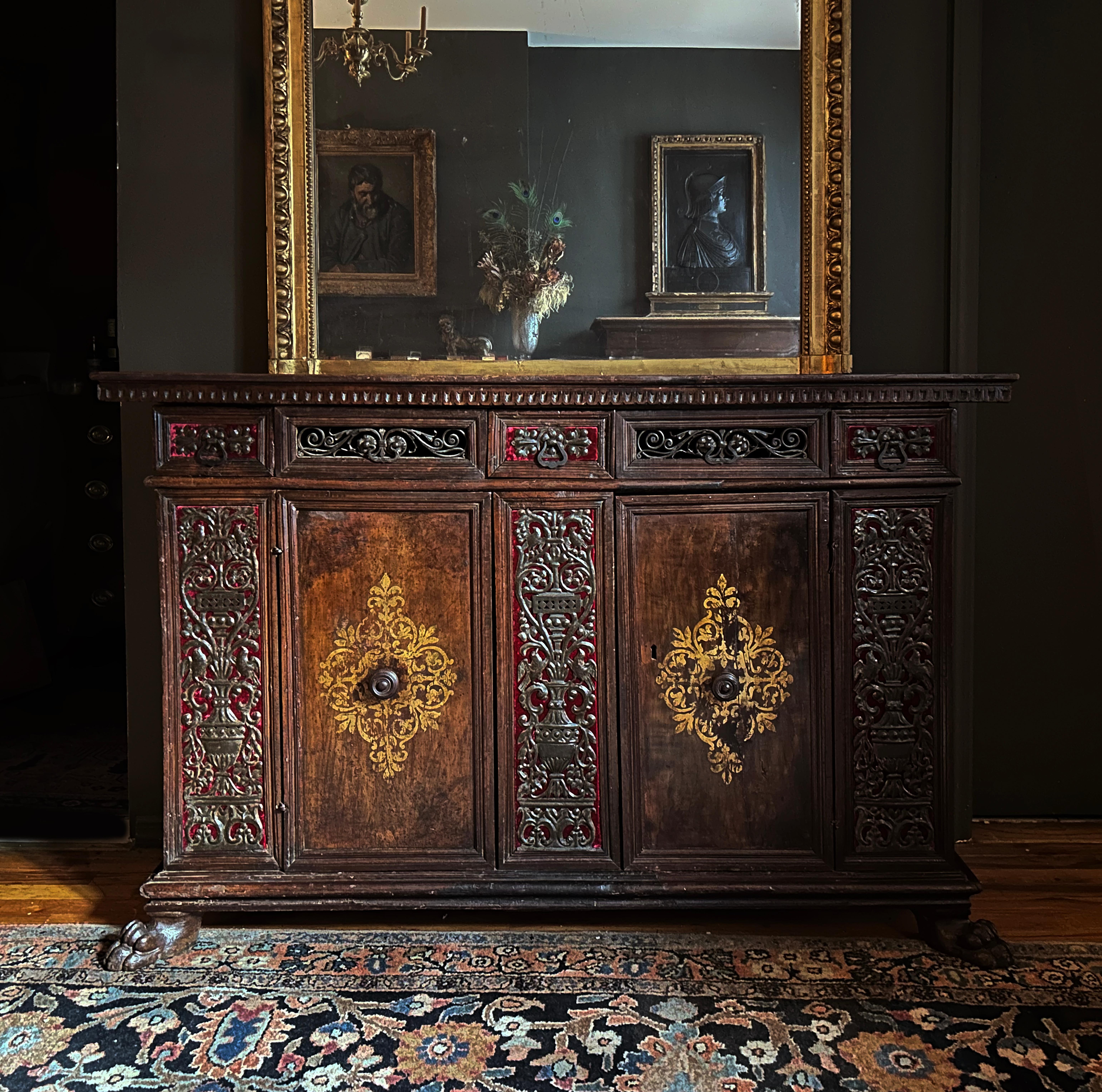 A spectacular and finely detailed late Renaissance credenza likely created in Florence.  A plank top is supported by a series of three frieze drawers with open wrought iron grilles of scrolling and acanthus leaves.  The case with two parcel gilt