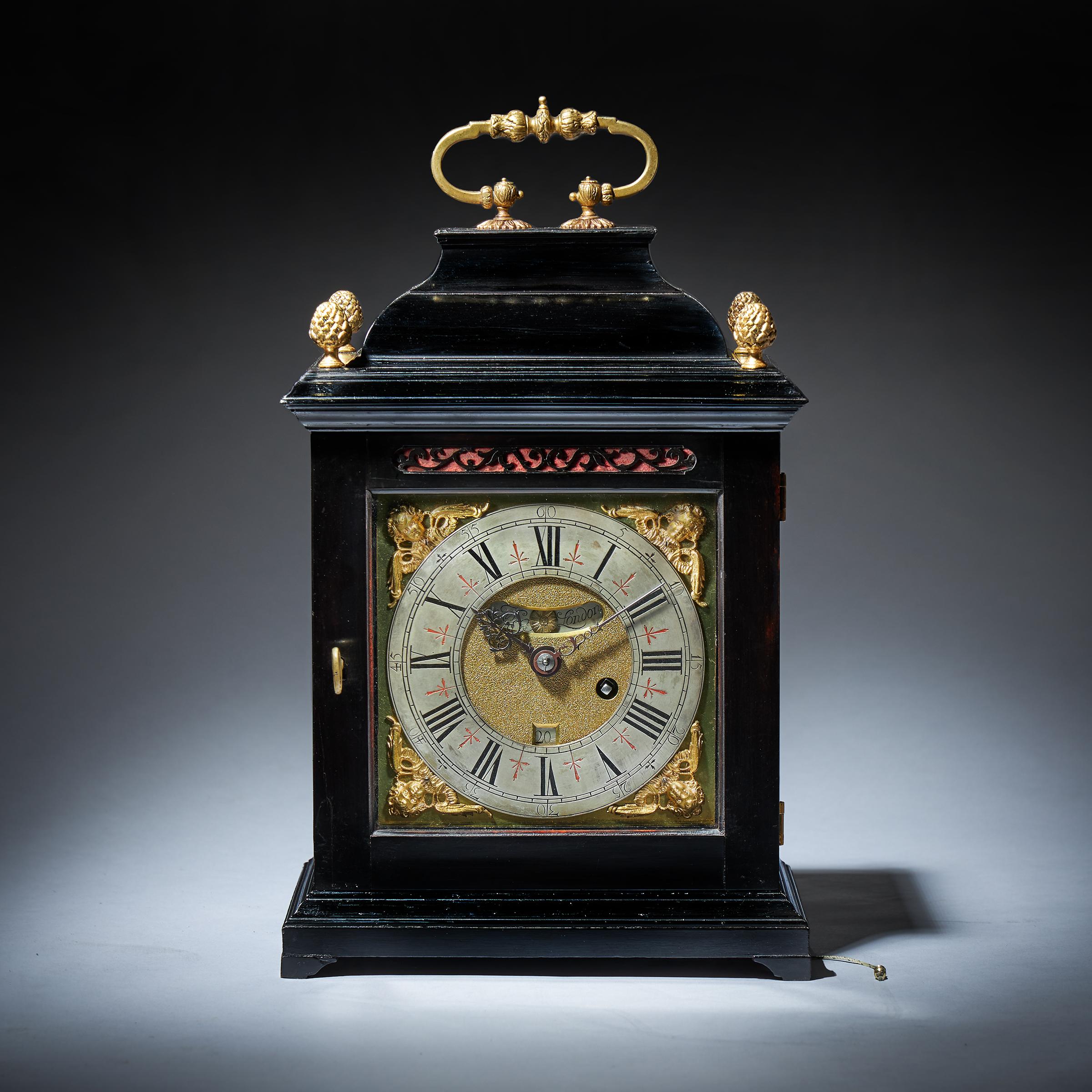 An early English eight-day spring-driven table clock signed Henry Massy London, dating to the period c.1695-1700. 

The elegantly proportioned ebony-veneered early inverted bell top case has windows on all sides so that the movement and the