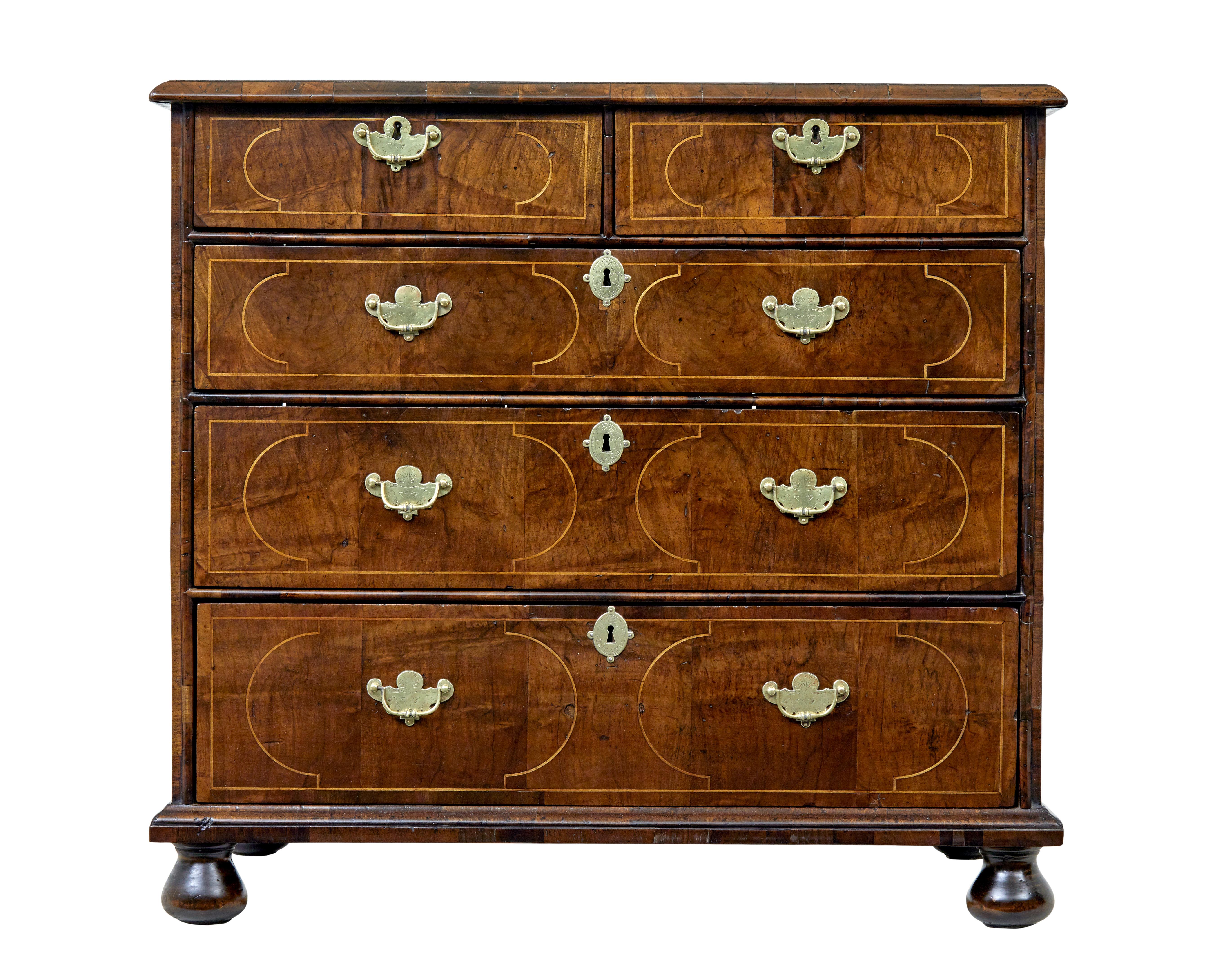 17th century William and Mary inlaid walnut chest of drawers circa 1690.

Good quality William and Mary period 2 over 3 drawer commode.

Top surface with inlaid circle and semi circular design, cross-banded border complete with a moulded edge. 