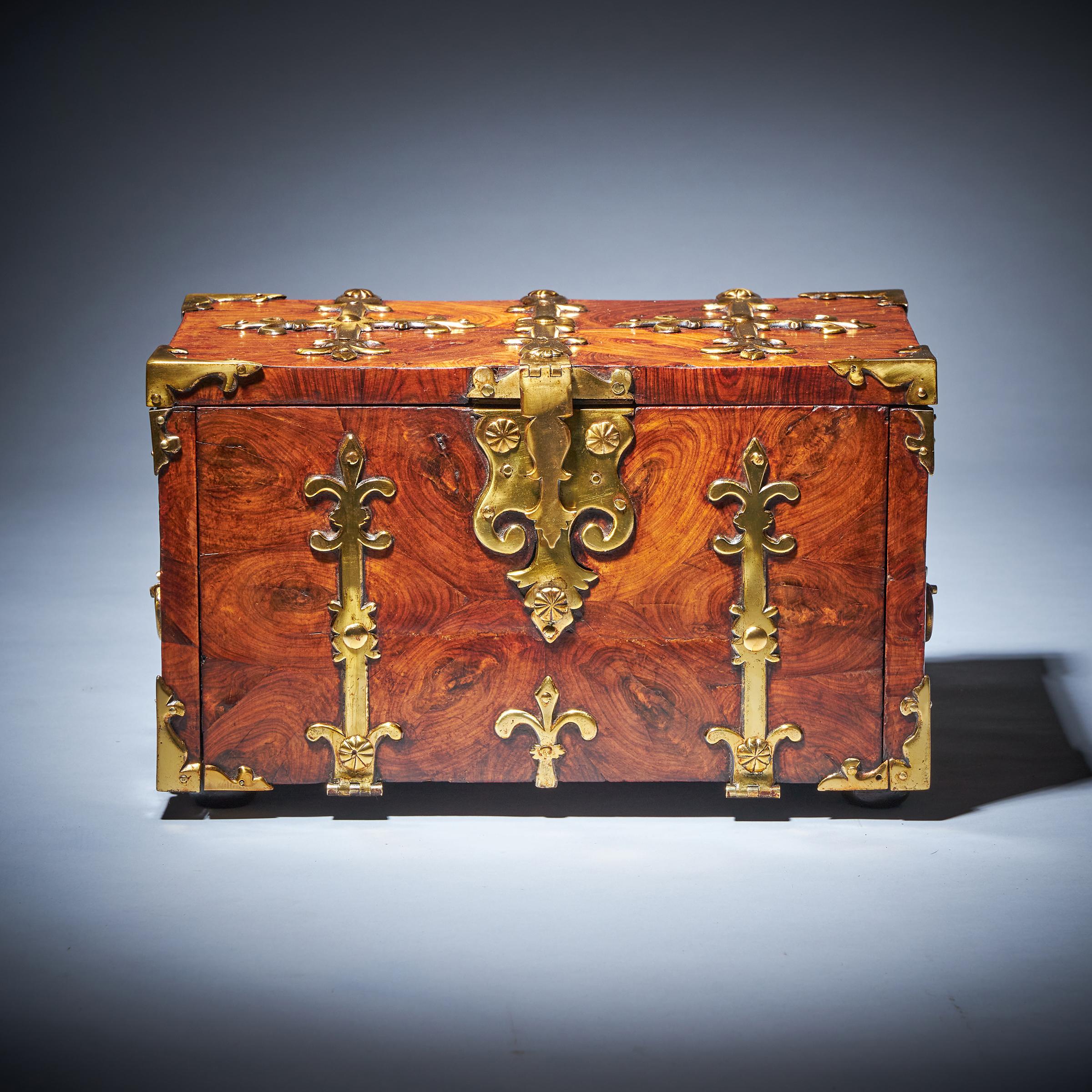 A superb William and Mary Kingwood / Princes Oyster strongbox or coffre fort of small proportions, circa 1680-1700, England. 

Adorned with highly decorative thick gilt brass strapwork and decorated entirely in knife cut oysters of kingwood, this