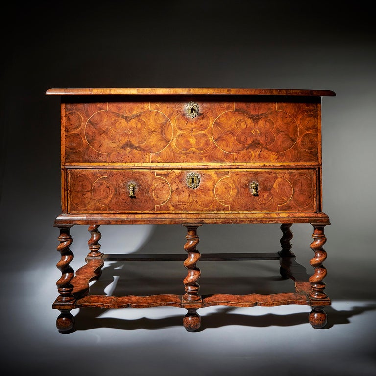 A fine and extremely rare 17th century William and Mary baroque olive oyster chest on stand or 'table box', circa 1675-1690. 
 
The exquisitely designed top, cross-grain moulded and holly banded, is decorated in many symmetrical line strung