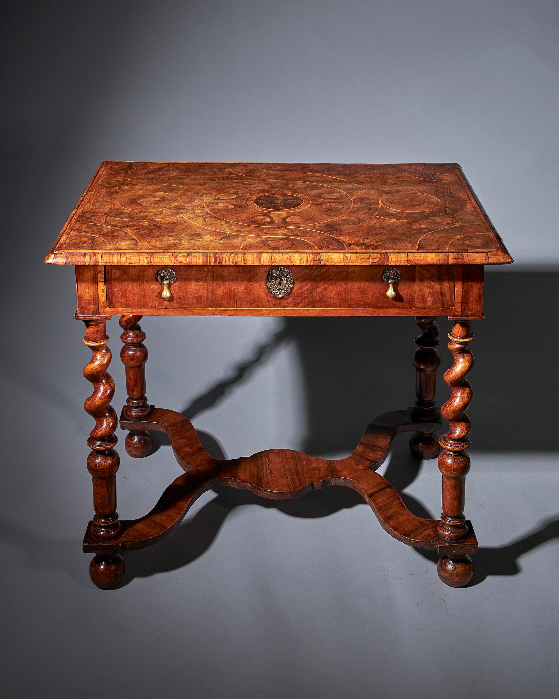 Exceptional and extremely rare 31” olive oyster table, circa 1670-1690. The original freely carved Solomonic or twist legs terminate on a reversed pear, joined by ‘y’ shaped stretcher veneered in cross grain olive, raised on all four original bun