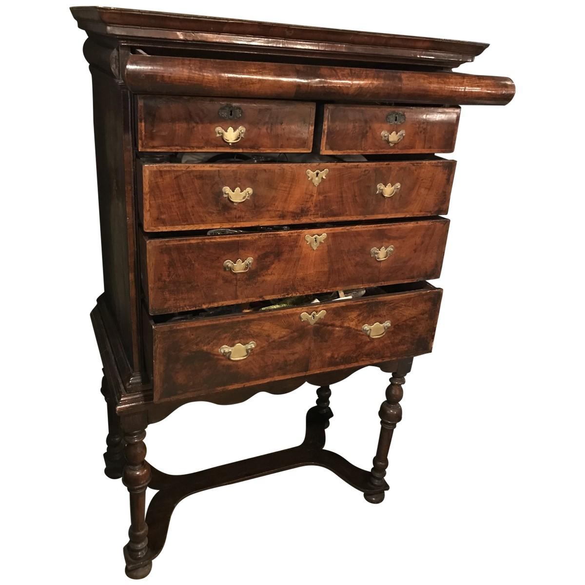 17th century a collectible piece from bygone days, featuring the finest craftsmanship, materials, and design elements of its given era. Elegant and ornate, this commanding chest-on-stand is composed of inlaid walnut with a walnut veneer. Multiple