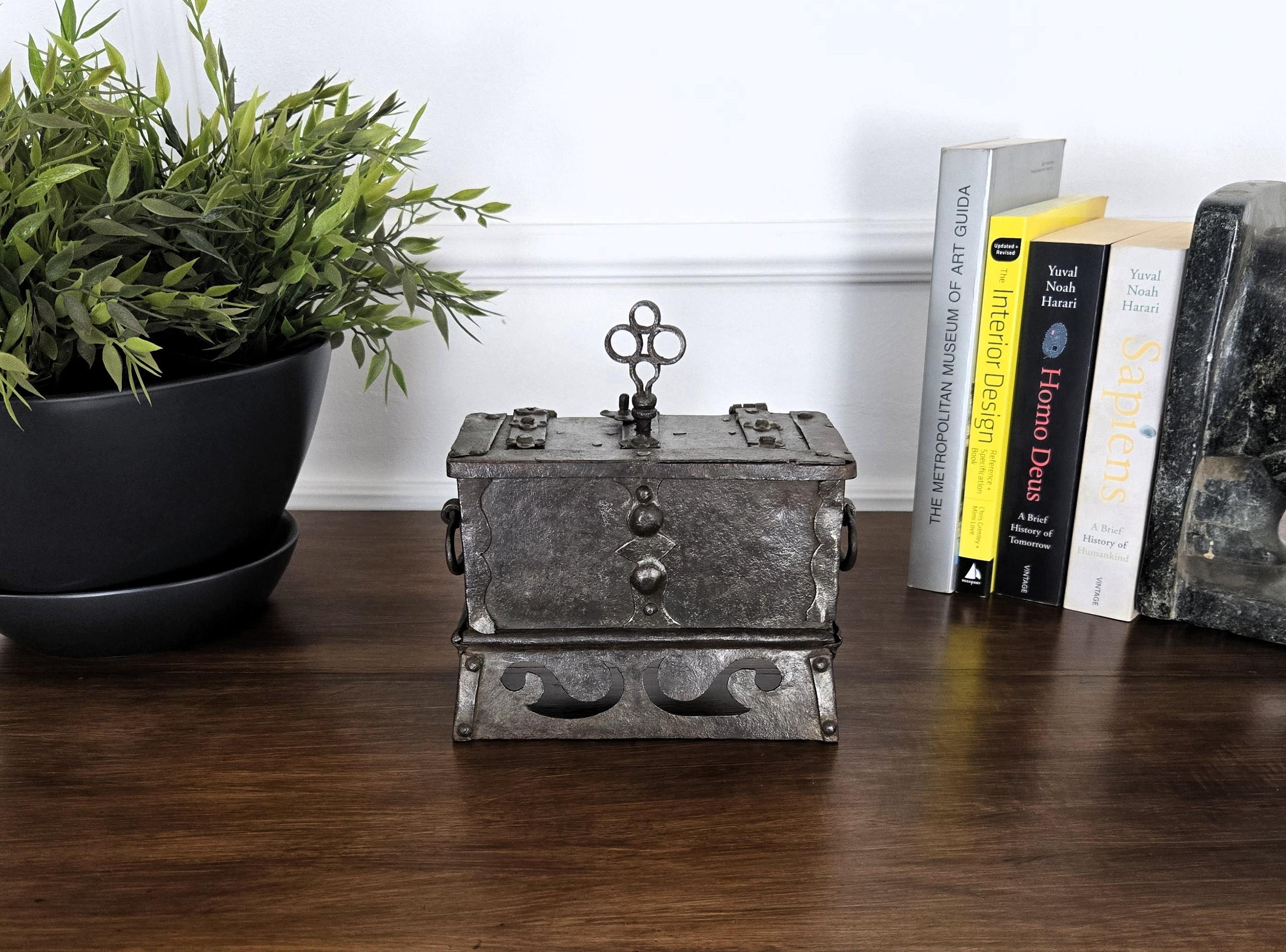 European miniature strongbox, dated circa 1600-1700. This little special piece has a beautiful metal color with patina of time and amazingly rich decorations, characterized especially by the outside hobnails and the engraved lock. The nice lock