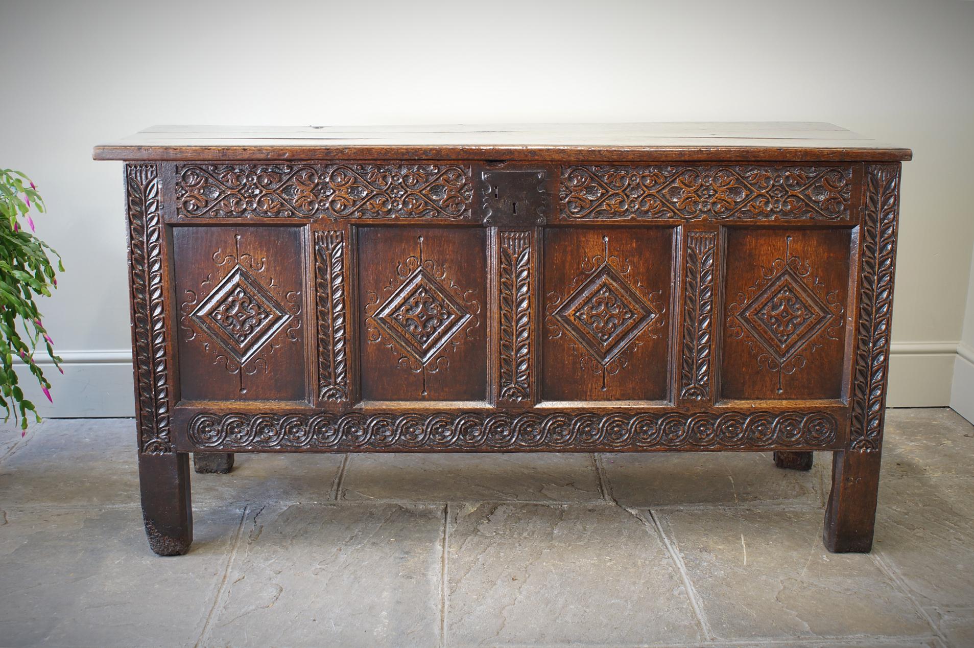 A superb example of a 17th Century  English coffer.  Having a planked lid, the front with a finely carved top rail, lozenge panels and stiff leaf stiles. All the carving is 
well executed and of a style associated with the North Yorkshire region of