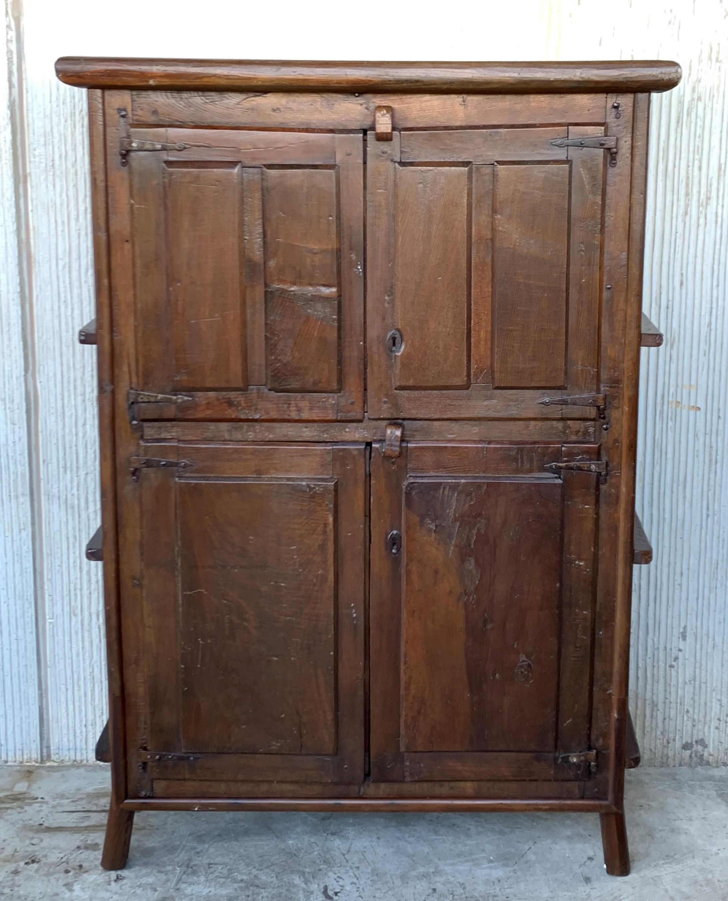 Grand 17th century Spanish armario or wardrobe armoire constructed from walnut. Features a coffered case fronted by four large doors. This massive cabinet made in Spain features beautiful walnut grain and showcases the amazing craftsmanship. There