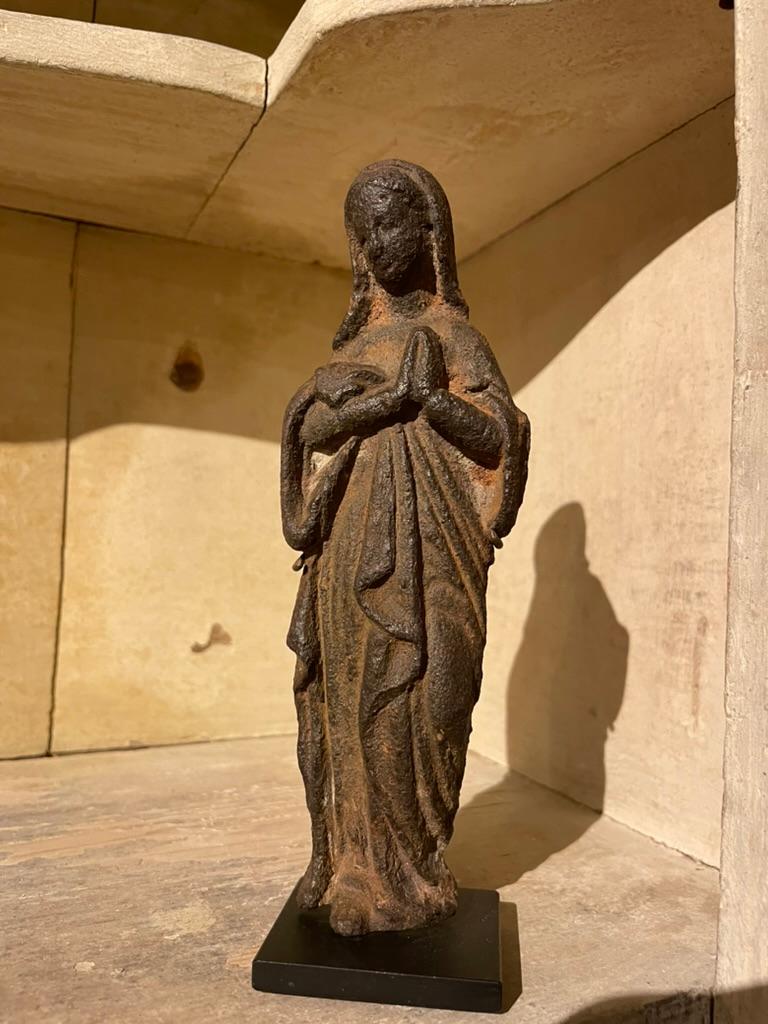 Wonderful 17th century French Baroque cast iron figure of the Virgin praying. Likely originally part of an outdoor shrine as it has been exposed to the elements. The weathered surface only adds character to this exquisite small sculpture. Despite