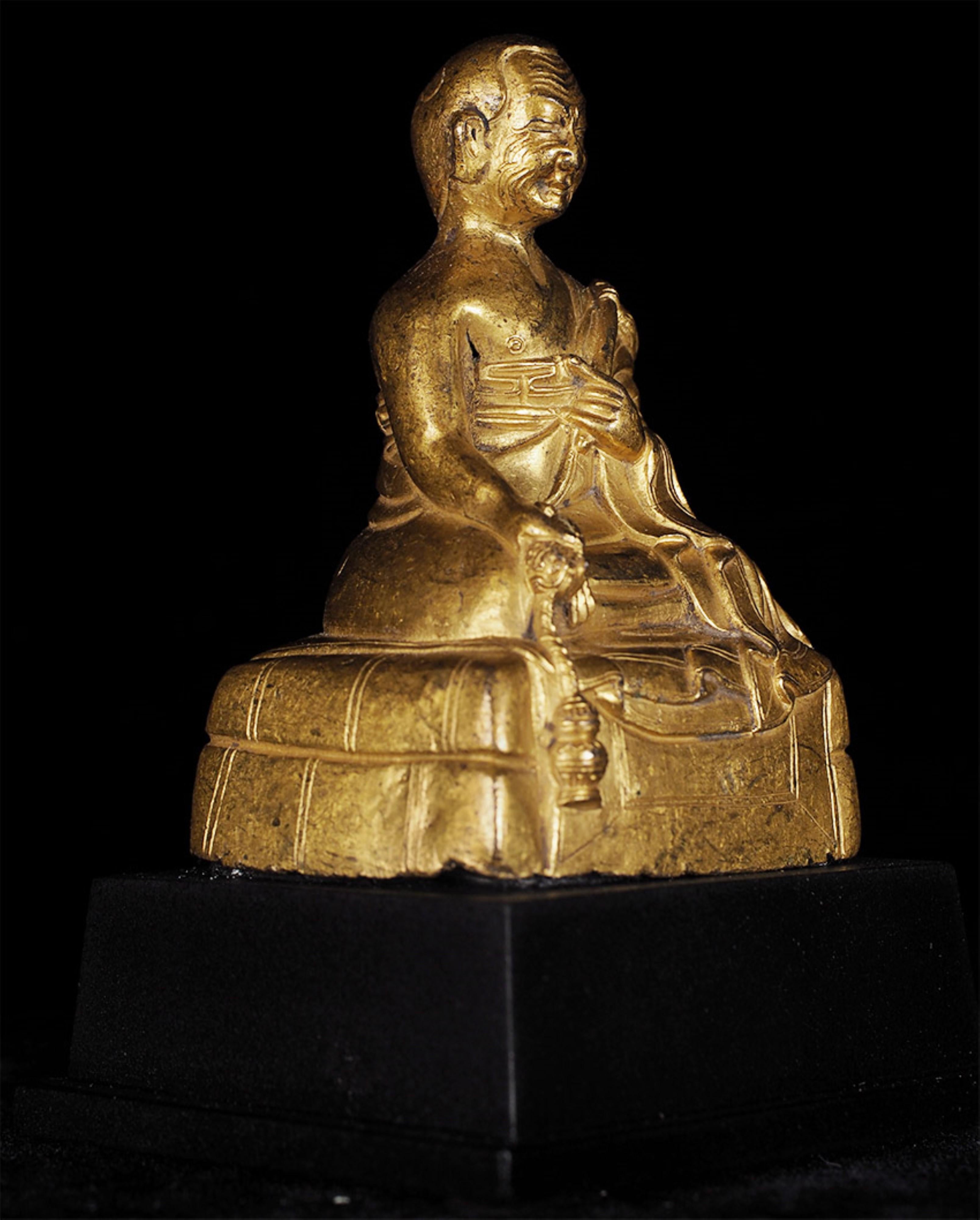 Remarkable 17thC or earlier Tibetan Buddhist Portrait Statue of a Monk in copper. Some damage to the back of the base in the spot where a hand would naturally apply pressure when holding it or picking it up.  He also  sits a little unevenly on the