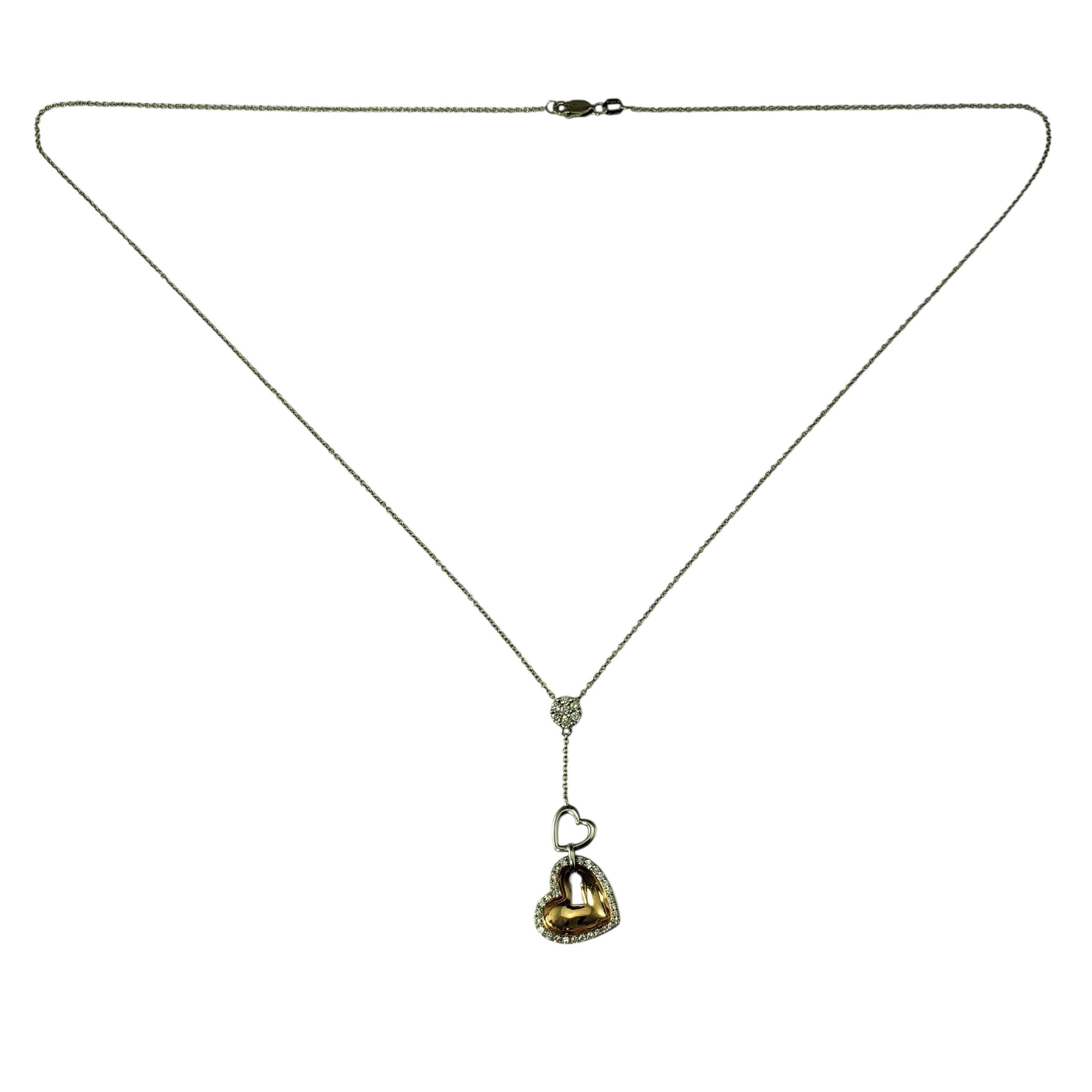 18/14 Karat Two-Tone Gold and Diamond Heart Necklace-

Elegant and romantic, this Y-style necklace showcases a beautiful blend of warm and cool tones with sparkling detail. The drop design features a delicate open heart leading to a rich 18K yellow