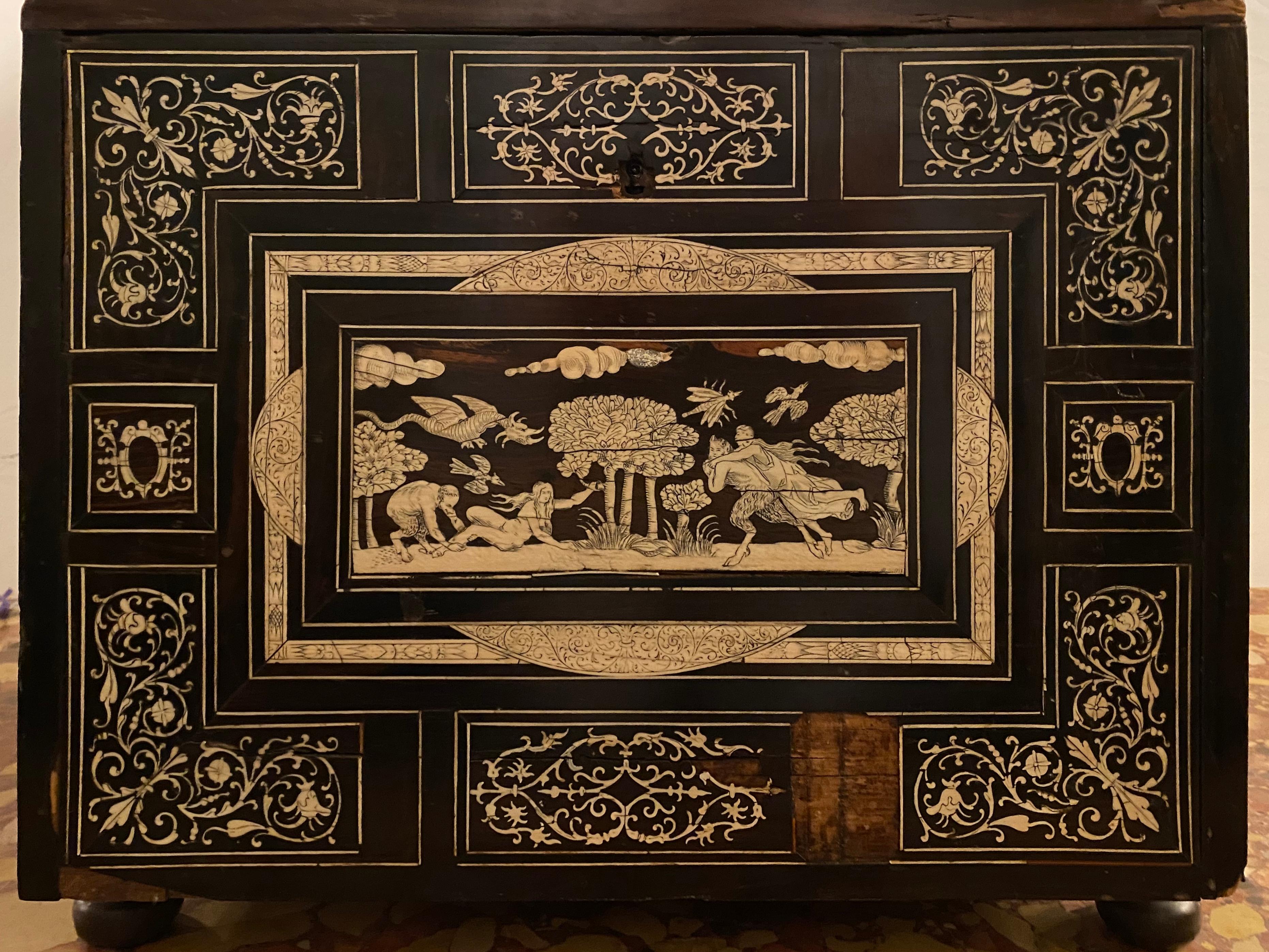 Box 18th-19th century. Rosewood and ebony Italian table cabinet with bone inlays geometrically inlaid with box wood and bone, the hinged drop down front revealing large center door with an inlaid roman solider guarding the bank of small pull out