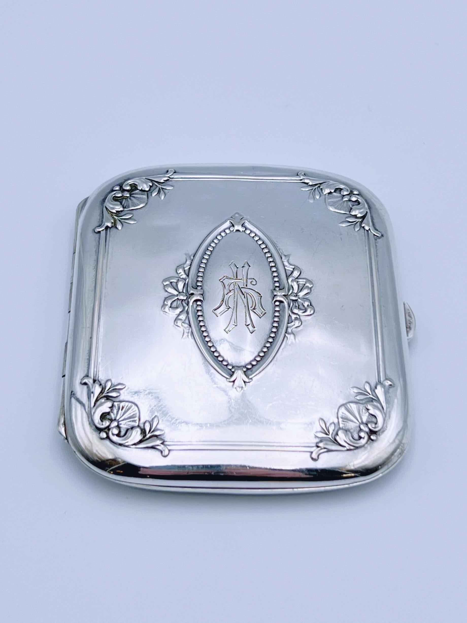 A stunning antique silver cigarette case in the classic Late Victorian style, dating from the late 19th to early 20th century (ca. 1890s-1910s). Crafted from solid Norwegian 830s fine silver, featuring exquisite relief details and 24k gold gilt on