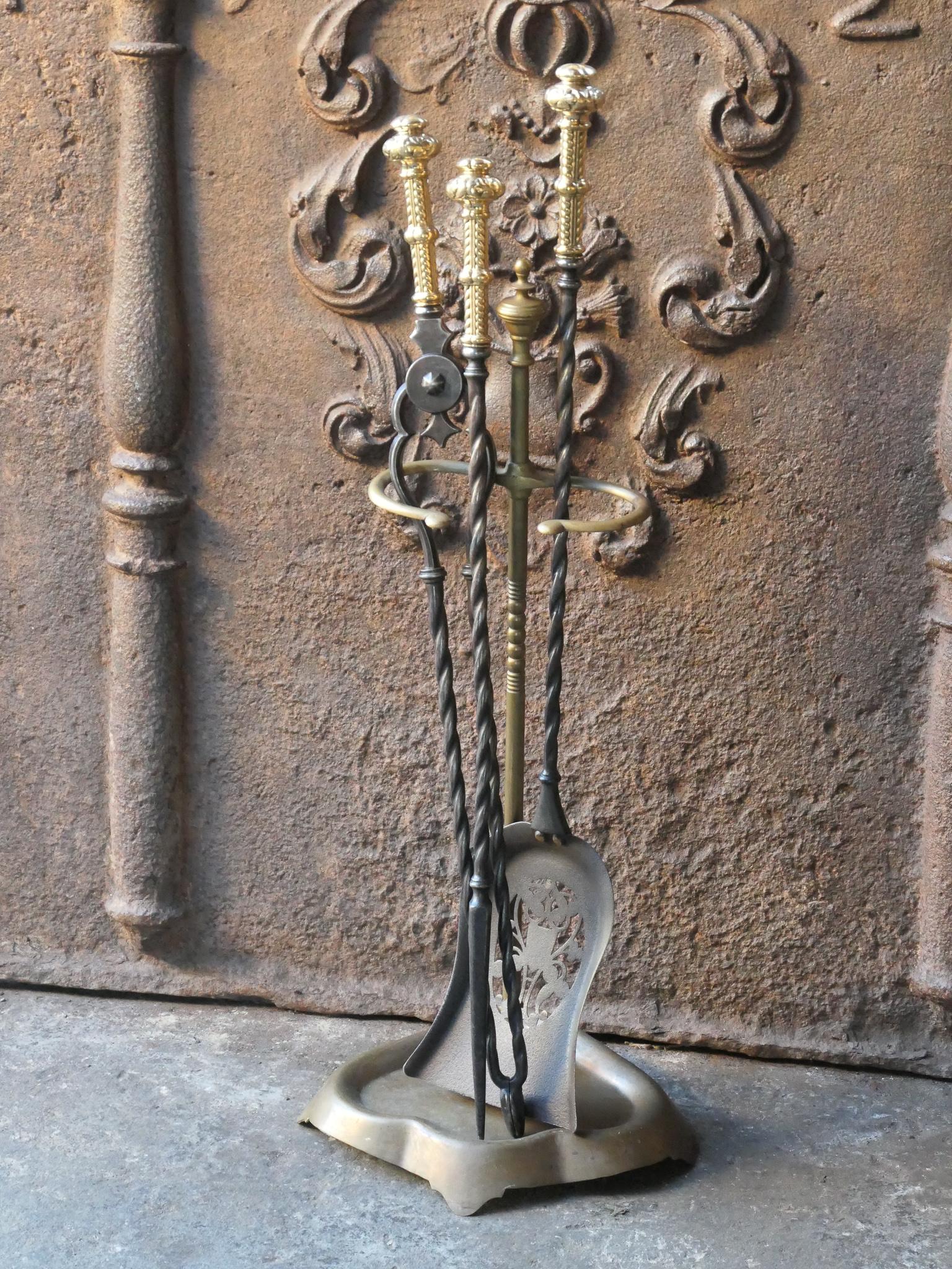 18/19th century English Georgian fireplace tools. The tool set consists of thongs, shovel, poker and stand. Wrought iron tools with polished copper handles and a brass stand. It is in a good condition and is fully functional.