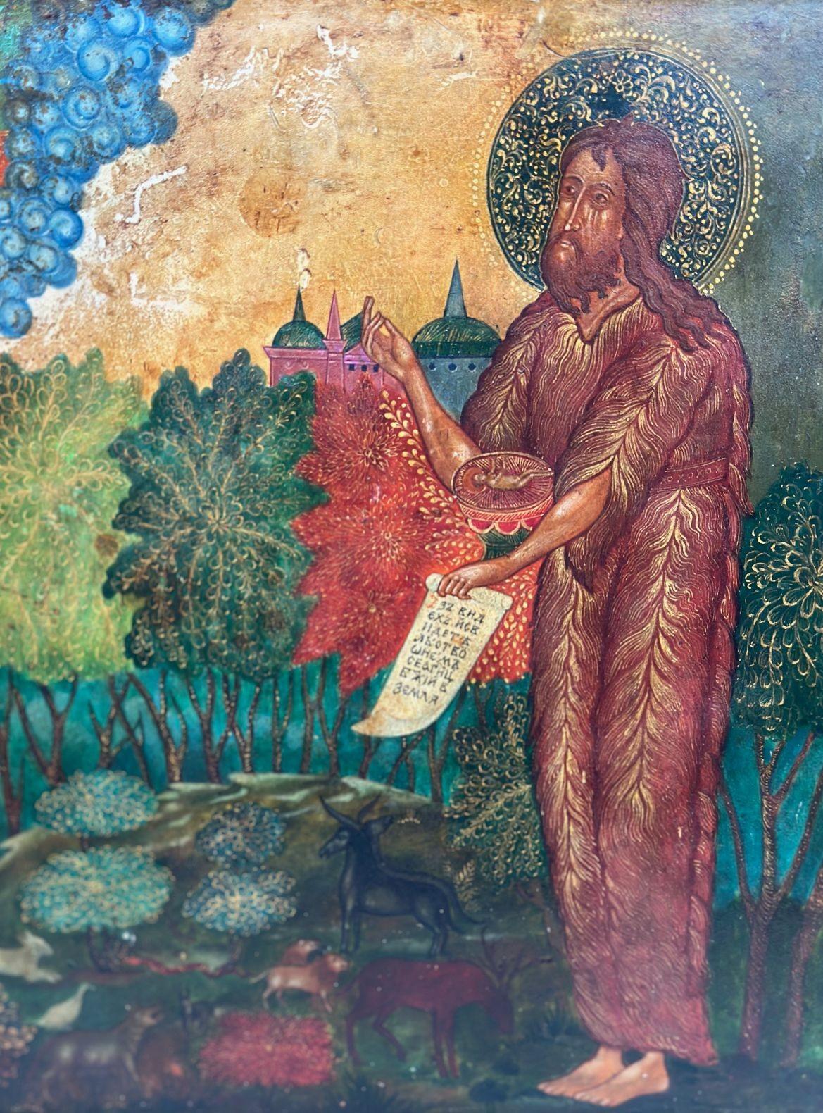 18/19th Century Russian icon of St. John (Angel of the Desert); shown holding a kind of salver, and in it — if we see it up close — is depicted the naked child Christ, lying down, symbolizing The Lamb of God of the Eucharist. He also holds a