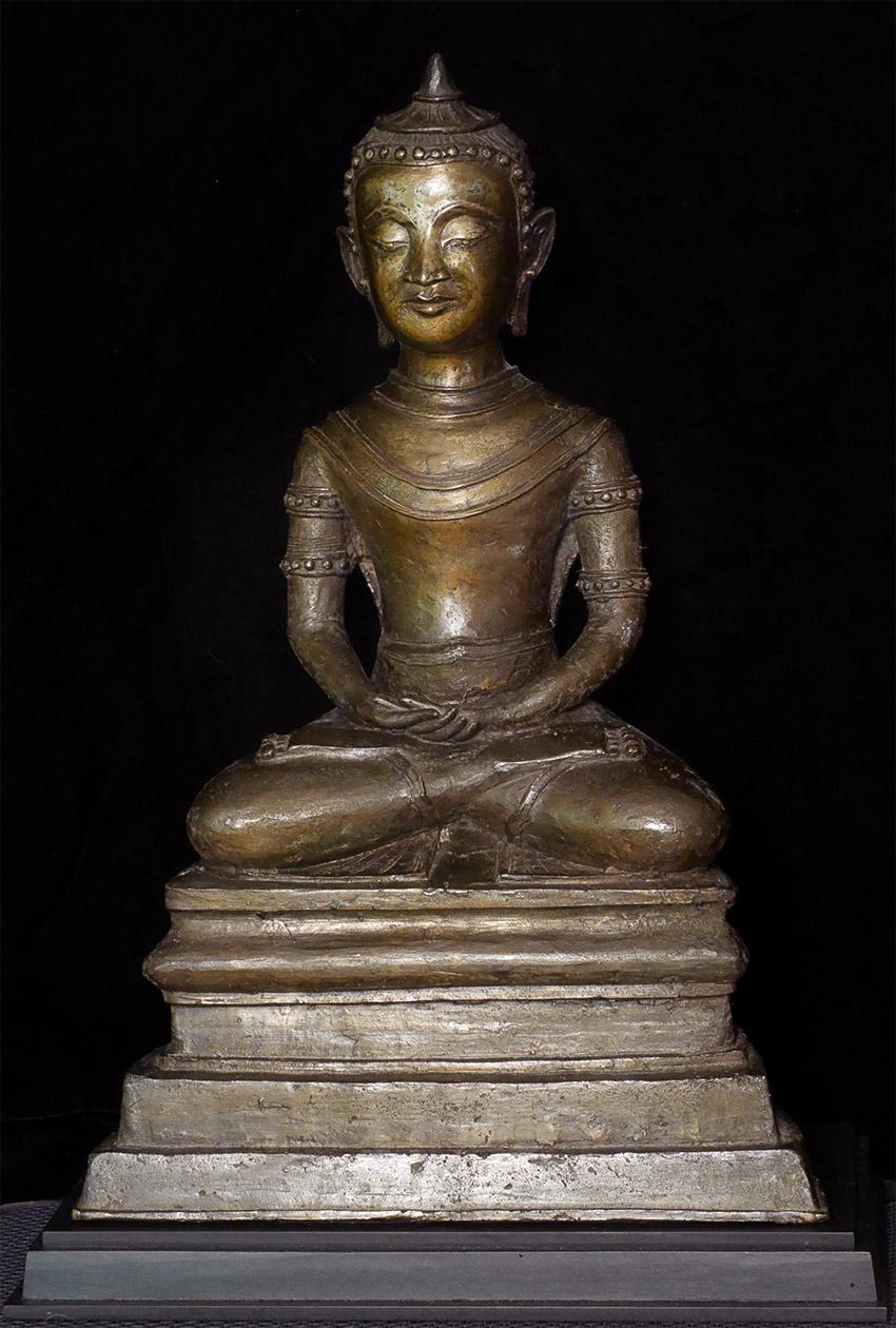 Compelling, large Burmese Buddha. It is unique in many ways. 

First, it looks like a specific person (as opposed to a sculpture of a generic figure), which is never ever done when sculpting a Buddha statue. 
Second, is it figure looks European.