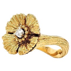 18 and 24 K gold ring with diamond centre.