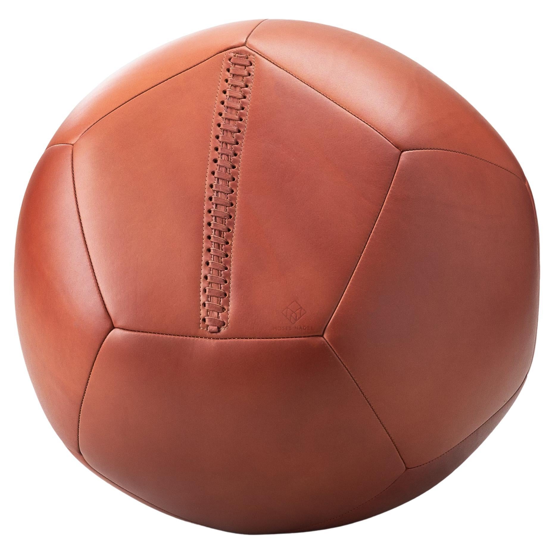 Functionality combined with elegance, the Ball Ottoman is a versatile piece of furniture. Sculptural with its round shape and playfully engaging, this leather ottoman is commonly used to rest your feet and as alternative seating. Handcrafted and