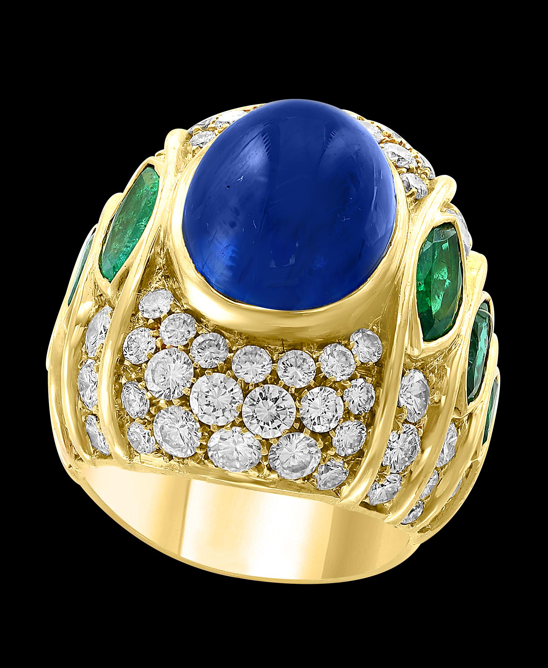 18 Carat Blue Sapphire Cabochon natural 
Diamonds 4.5 ct of  brilliant  Round cut diamonds.
3 Marquise shape Emeralds on each side.
18 K yellow gold 26 Grams
Unisex ring 
Ring size 6.5
If you need the ring resized, it can be done for free of charge,