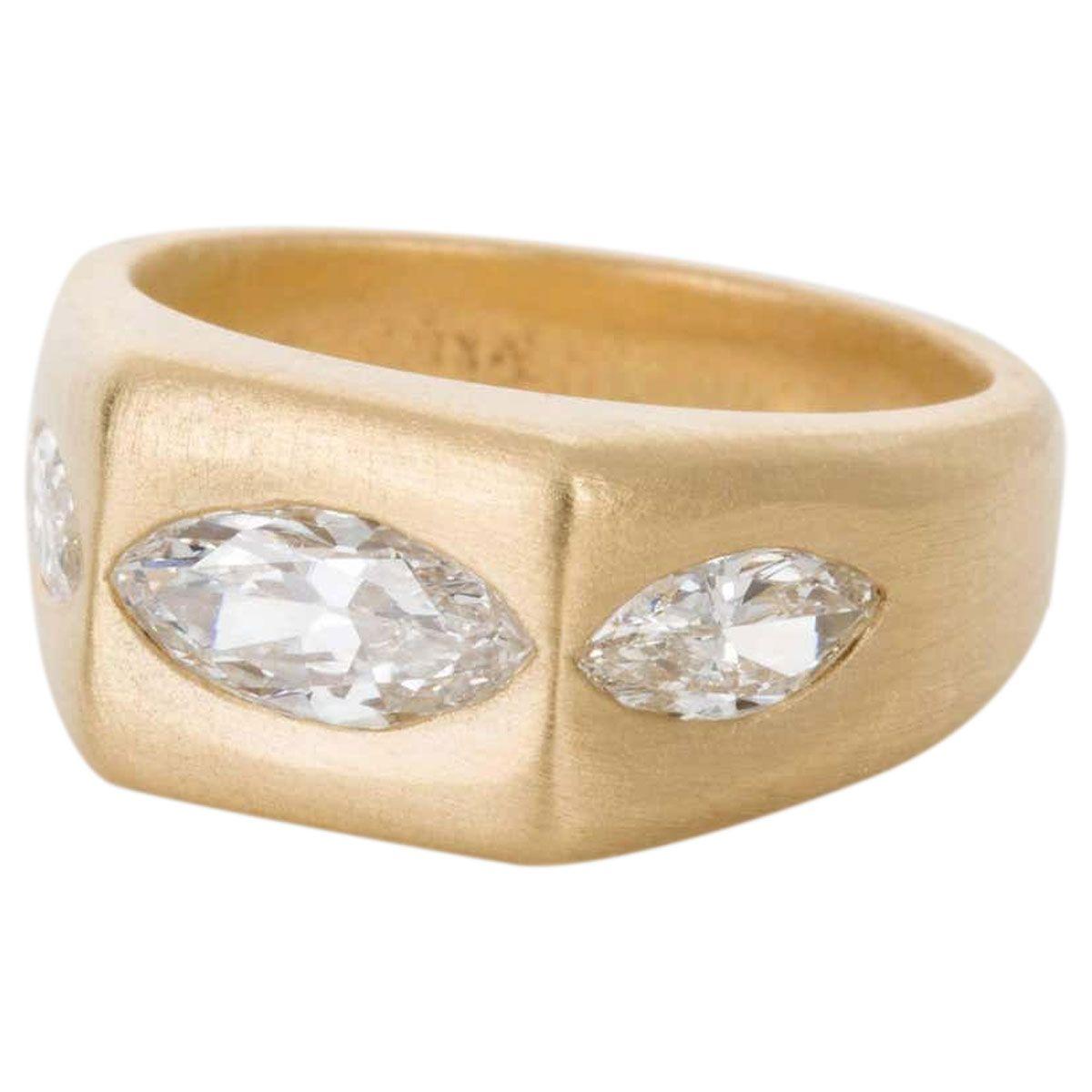 This ring is so wearable and fabulous. Three marquise cut diamonds hammer set into an 18k brushed yellow gold band, the diamonds weigh an approximate total of 1.72cts - H colour, VS2 - SI1 clarity. The brushed gold has so much contrast against the