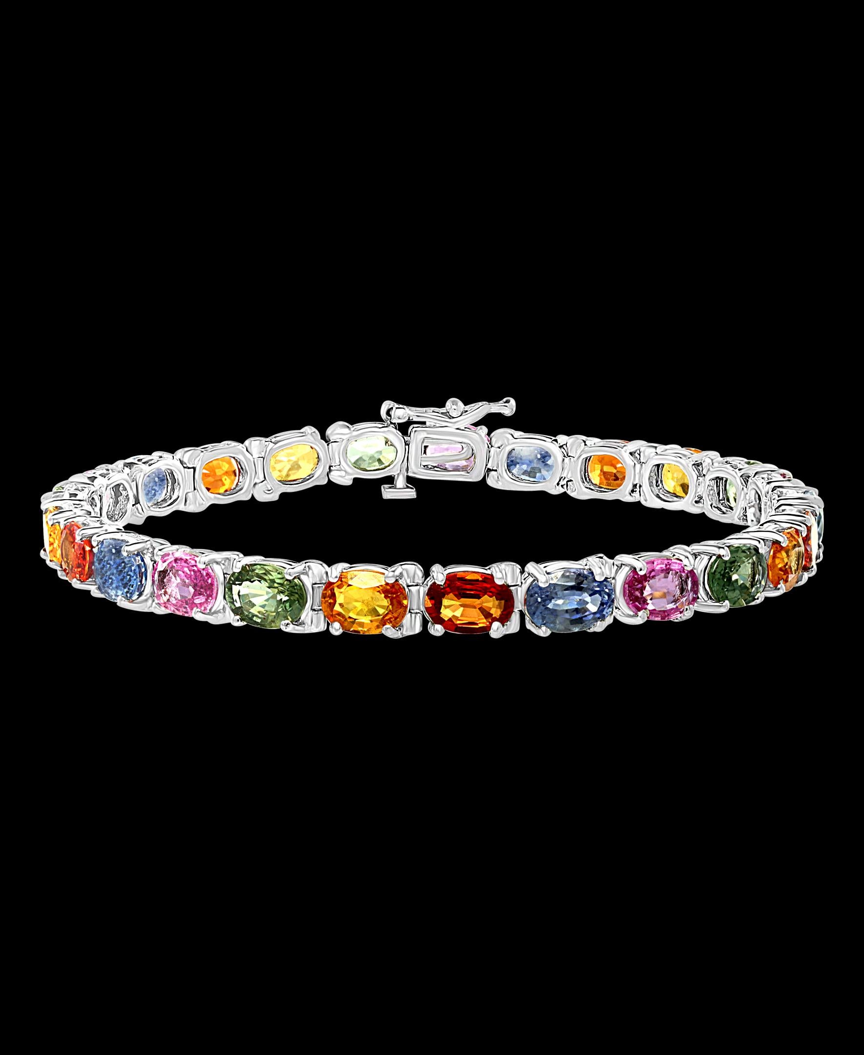  This exceptionally affordable Tennis  bracelet has  25 stones of oval Sapphires  . 
 Sapphires  colors are Pink, Blue, Orange, Yellow, Green
Beautiful colors , very Vibrant
Size of the stone is approximately 7X5 mm
Total weight of these natural