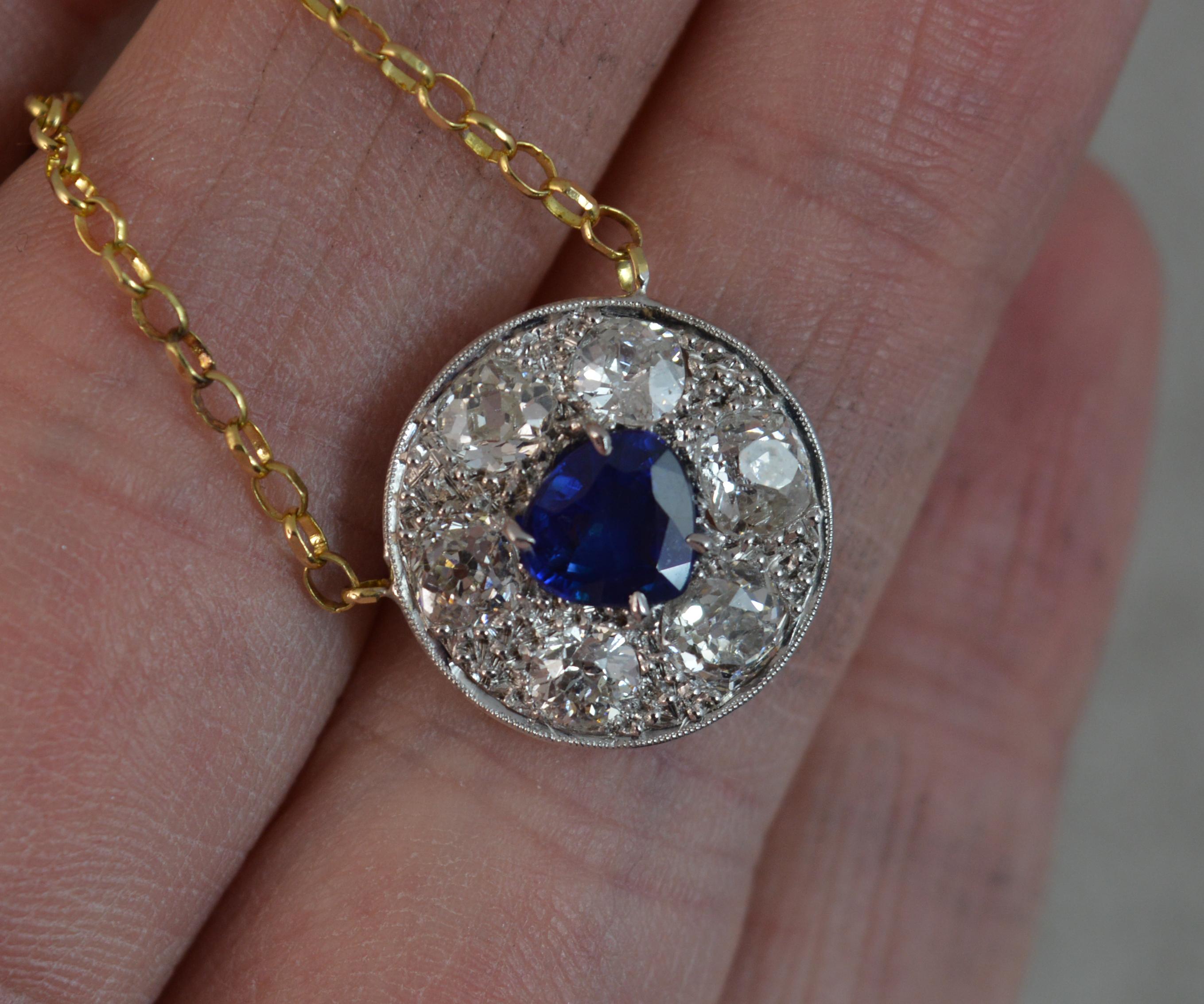 A fantastic antique pendant necklace.
Stylishly shaped with circular cluster pendant. Set with a cushion trillion cut bright blue sapphire to centre with six old cut diamonds surrounding.
Total diamond weight approx 1.65 carats. Clean and