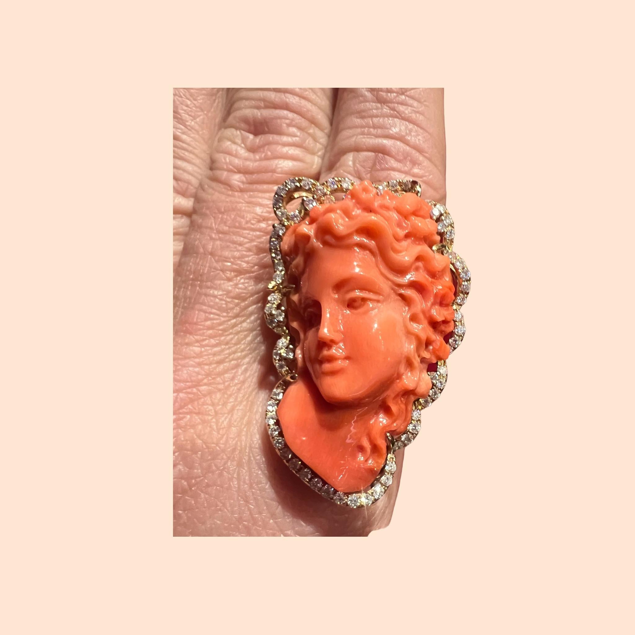 cocktail ring in 18 carat gold set with a superb cameo in coral surrounded by diamonds
spectacular ring in 18 carat yellow gold set with a cameo in coral representing an elegant profile of a woman measuring
  about 4 centimeters surrounded by a