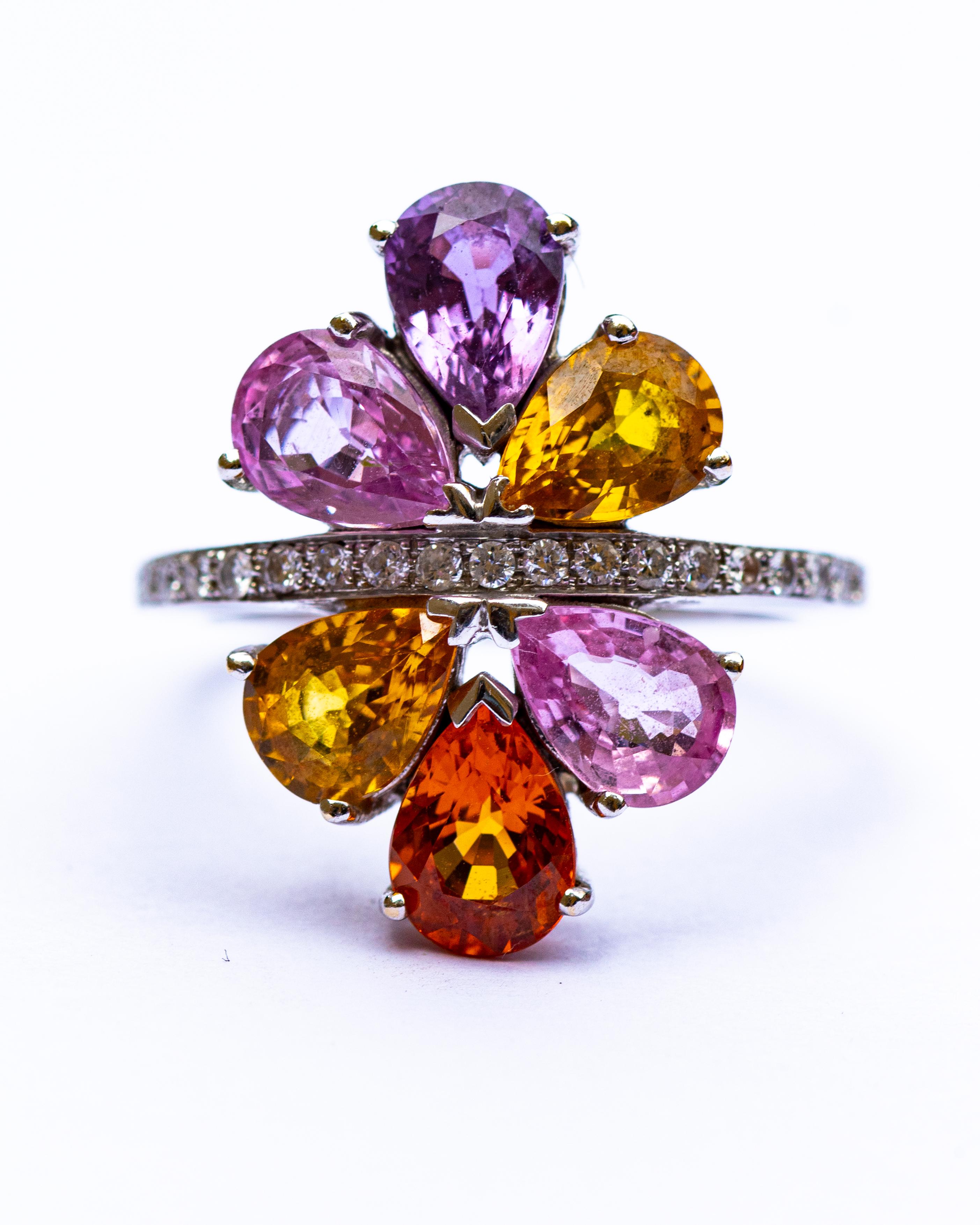An 18 carat gold diamond and multi gem set cluster ring, set with six pear cut stones, on a diamond set band, size M, marked EJ, 5.9g weight.