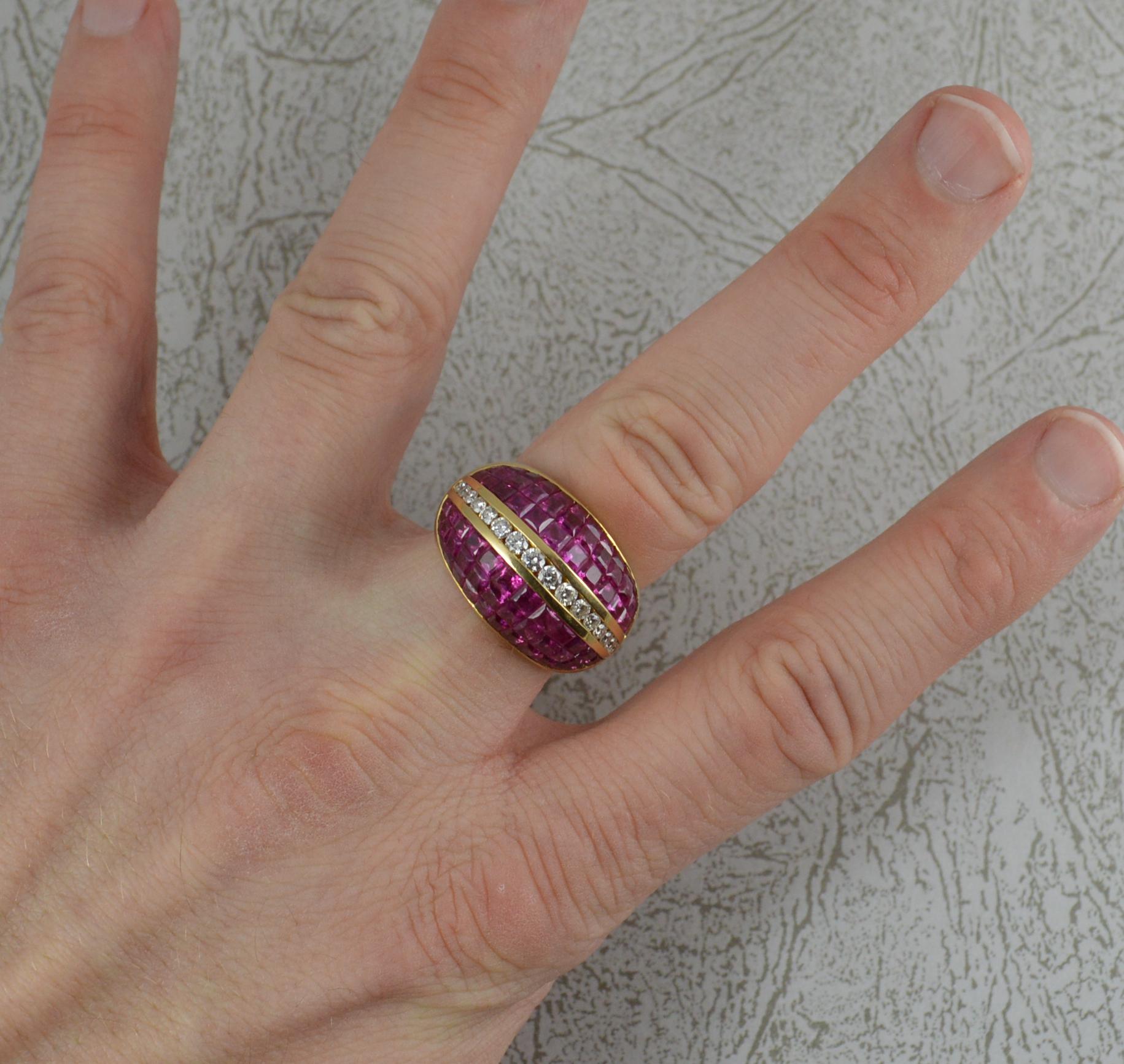 A stunning ladies vintage bombe cluster ring.
Solid 18 carat yellow gold piece.
23mm spread of stones, 15mm wide band to front.
Designed with a row of channel set round brilliant cut diamonds to the centre, sixteen diamonds total approx half a