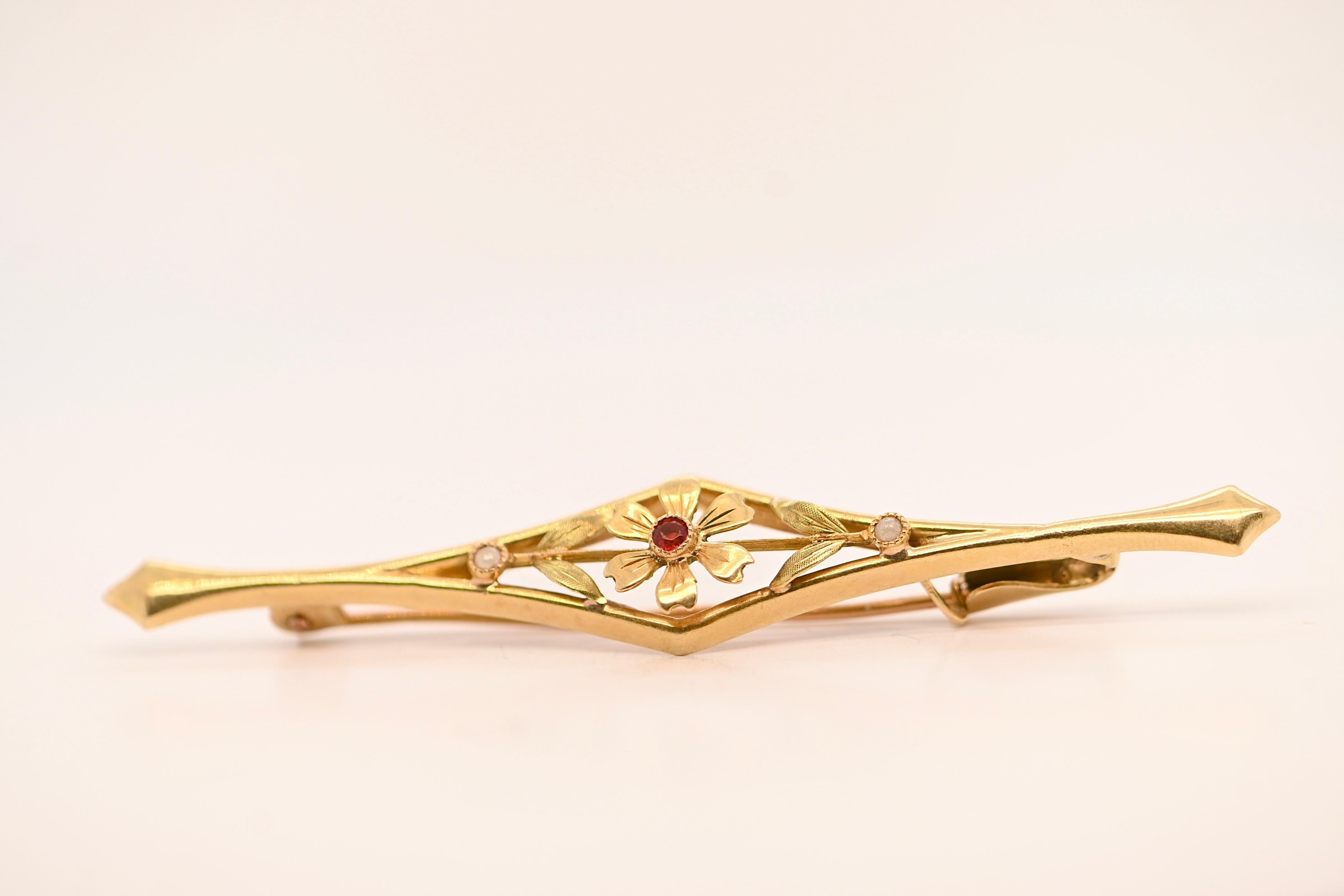 Artisan 18 Carat Gold Flower Brooch Adorned With A Ruby For Sale
