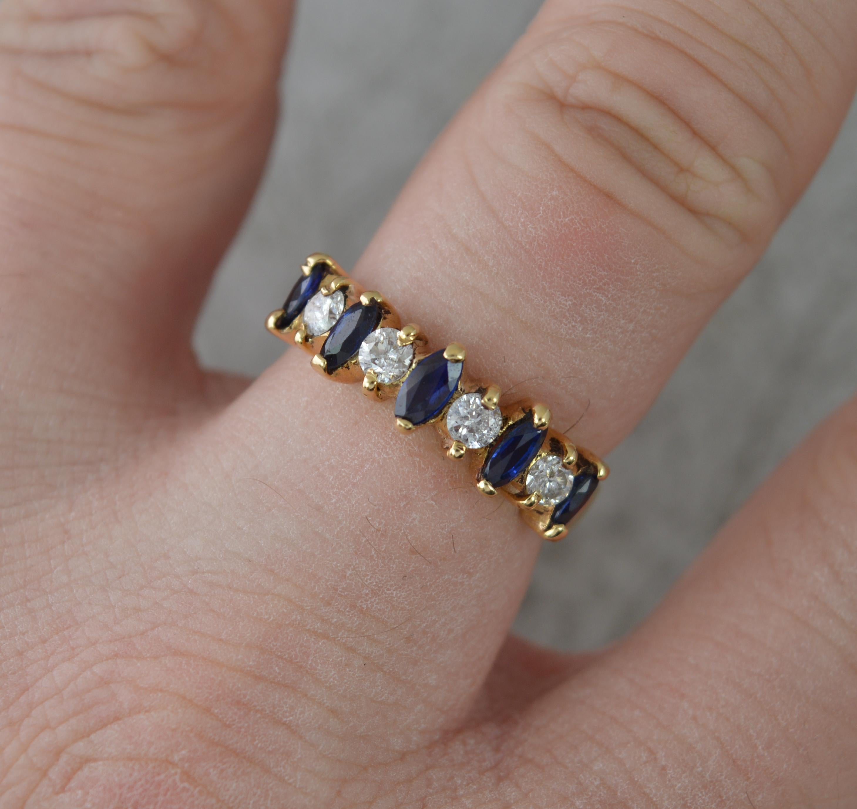 A very fine sapphire and diamond stack ring.
Solid 18 carat yellow gold example.
Set with alternating marquise cut blue sapphires and round brilliant cut white diamonds. 0.4cts of diamond.
20mm spread of stones. Protruding 3.5mm off the