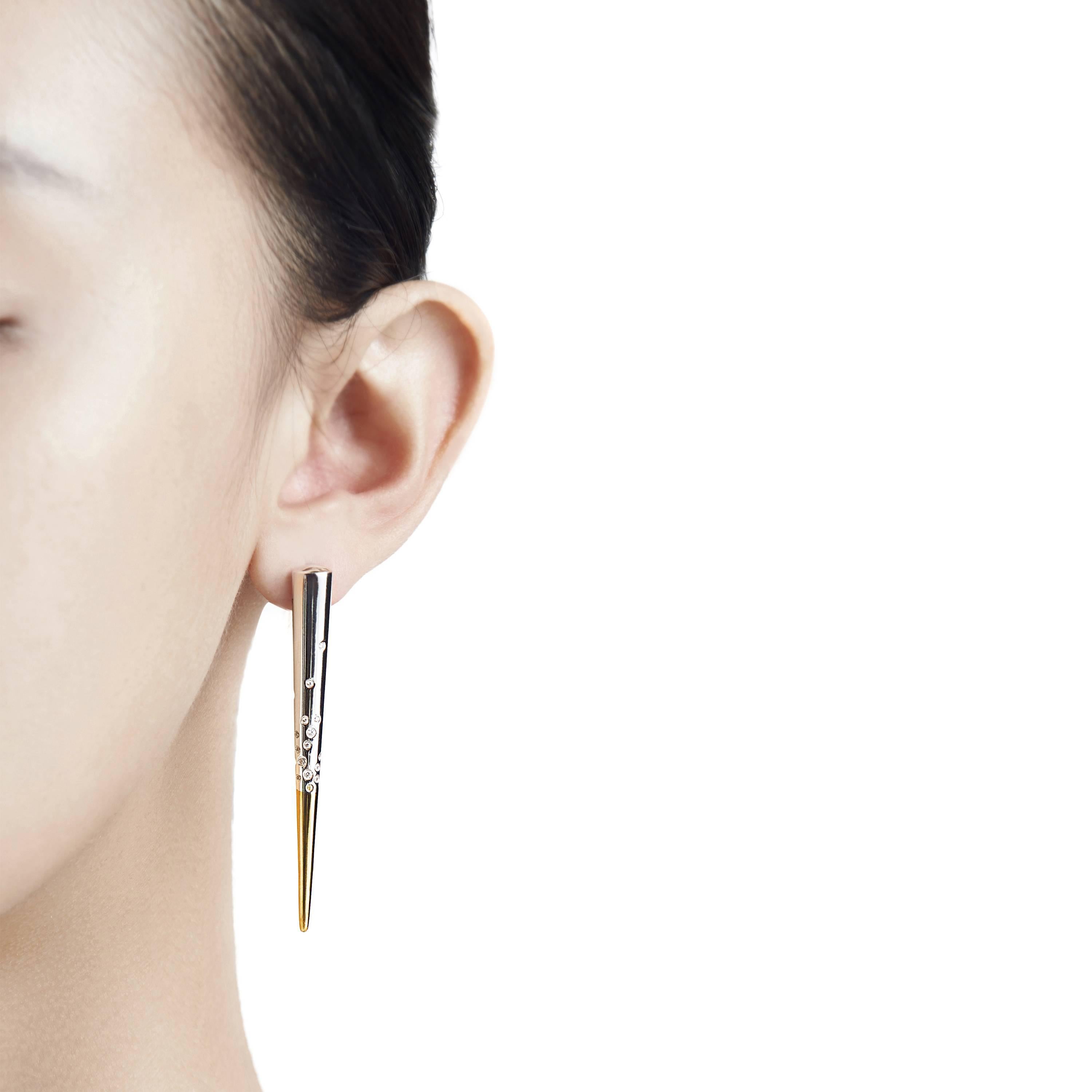 The Particle Earrings, by Mistova, are from the NOVA 01 collection which explores the transition from square to round. The earrings are made from 18k yellow and white gold and diamonds.  