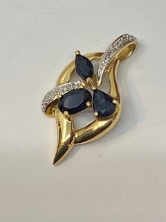 18 Carat Gold Pendant Set with 3 Pear, Shaped Sapphires and 14 Diamonds