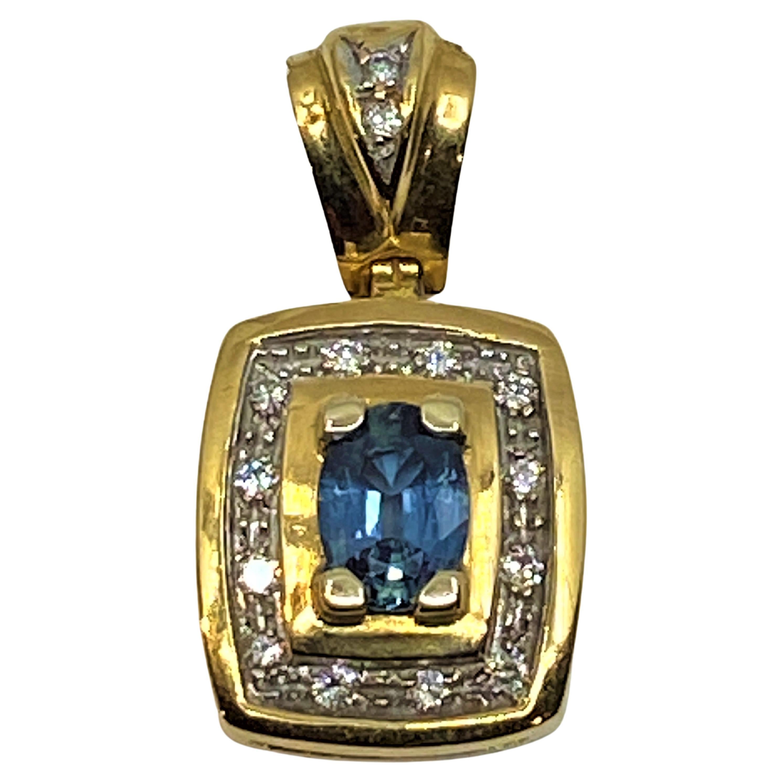 18 Carat Gold Pendant Set with a Sapphire and 14 Diamonds For Sale