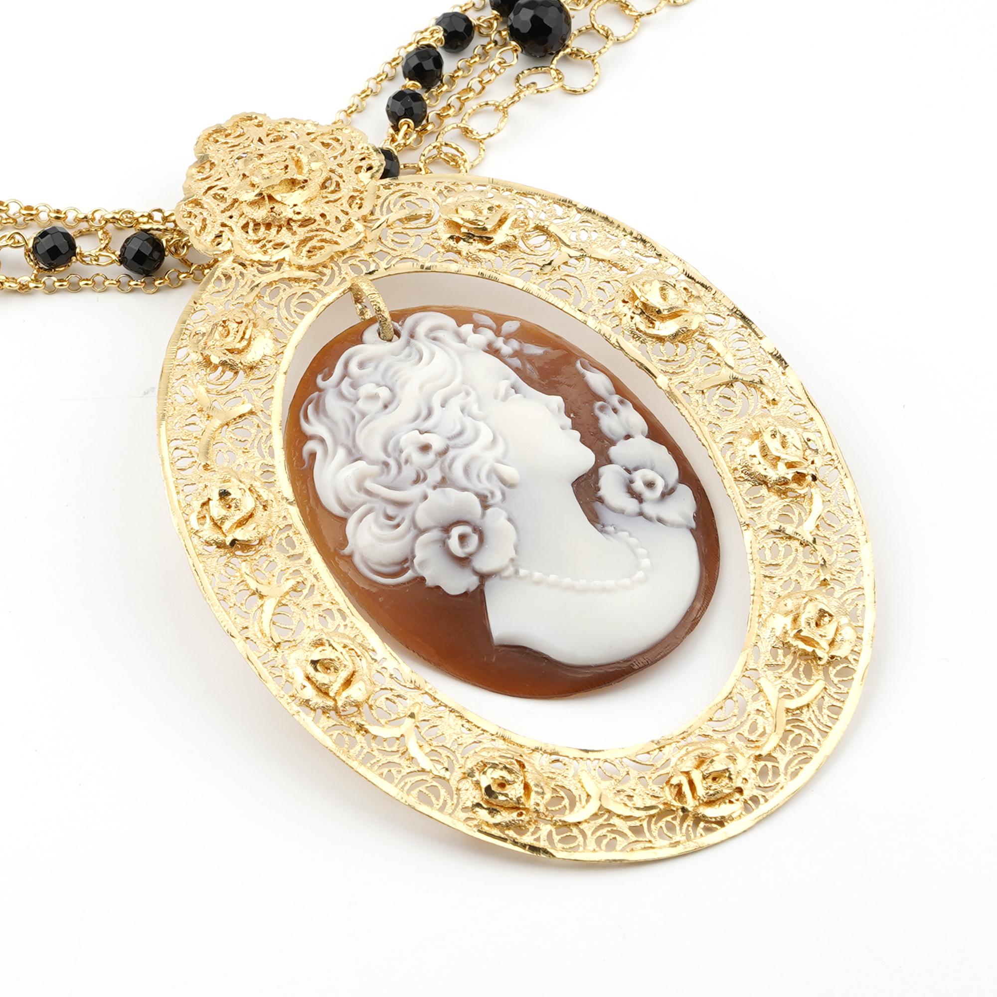 18Kt Gold Plated 925 Sterling Silver Sea Shell 45mm Cameo Necklace 95cm. Fully handcarved Portrait on a sea shell cameo set in a 18kt Gold plated silver pendant necklace with black onyx. Carvings are performed by our master artisans with generations
