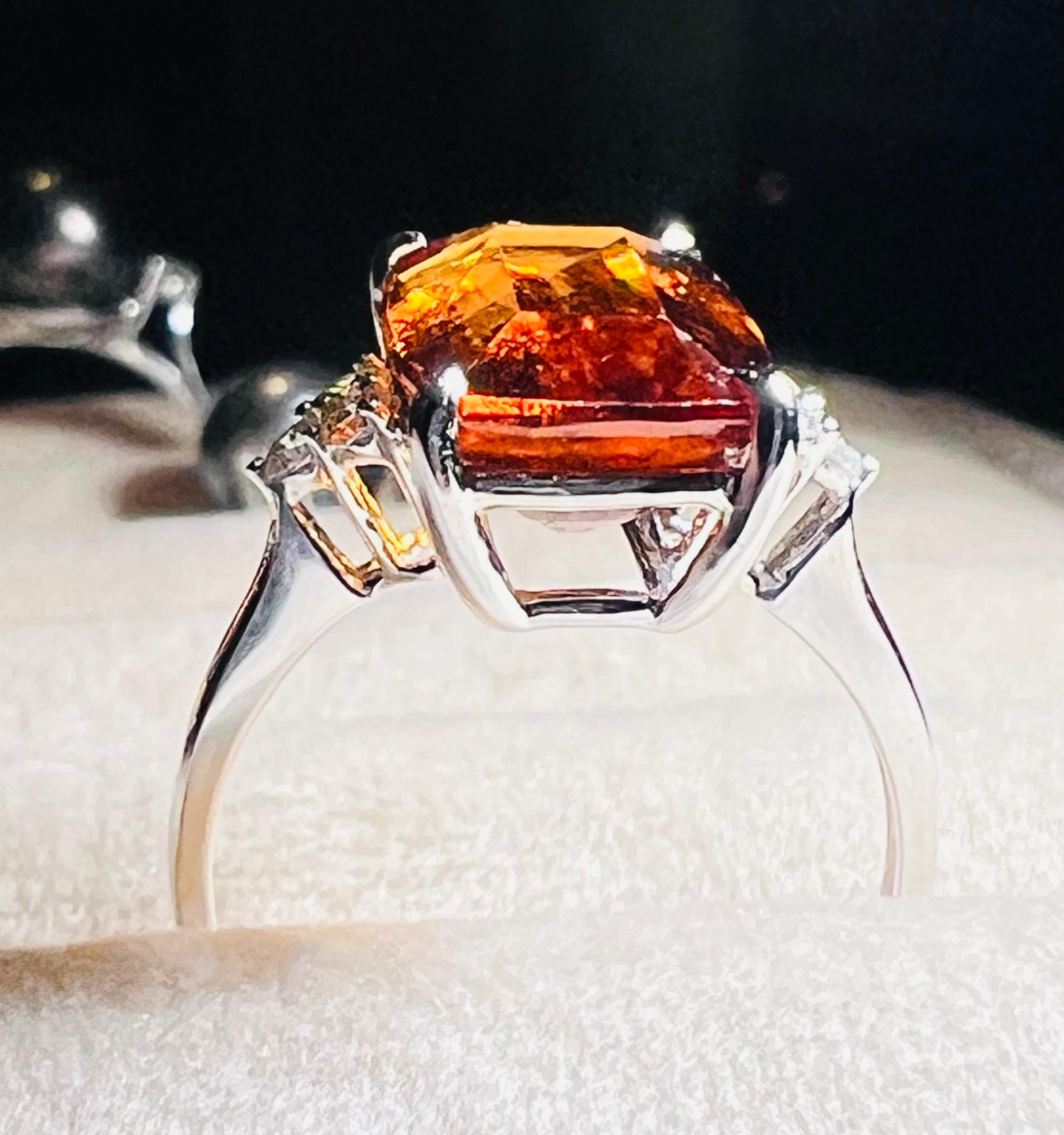 Elegant 18-carat white gold ring set with a luminous orange spesartite garnet, the cut and faceted stone is translucent, surrounded by 6 diamonds, this ring is radiant!
total ring weight: 3.95 gr
garnet weight: 6.40 carat
diamond weight: 0.17 carat
